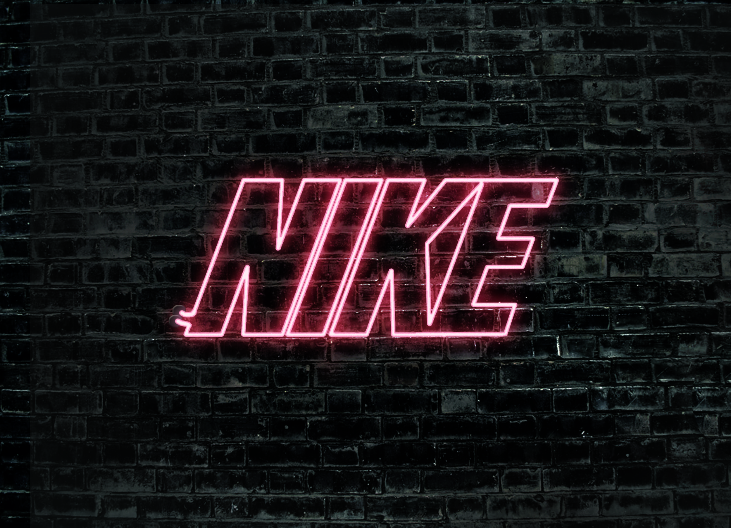 A brick wall with a pink neon sign that spells out Nike. - Nike