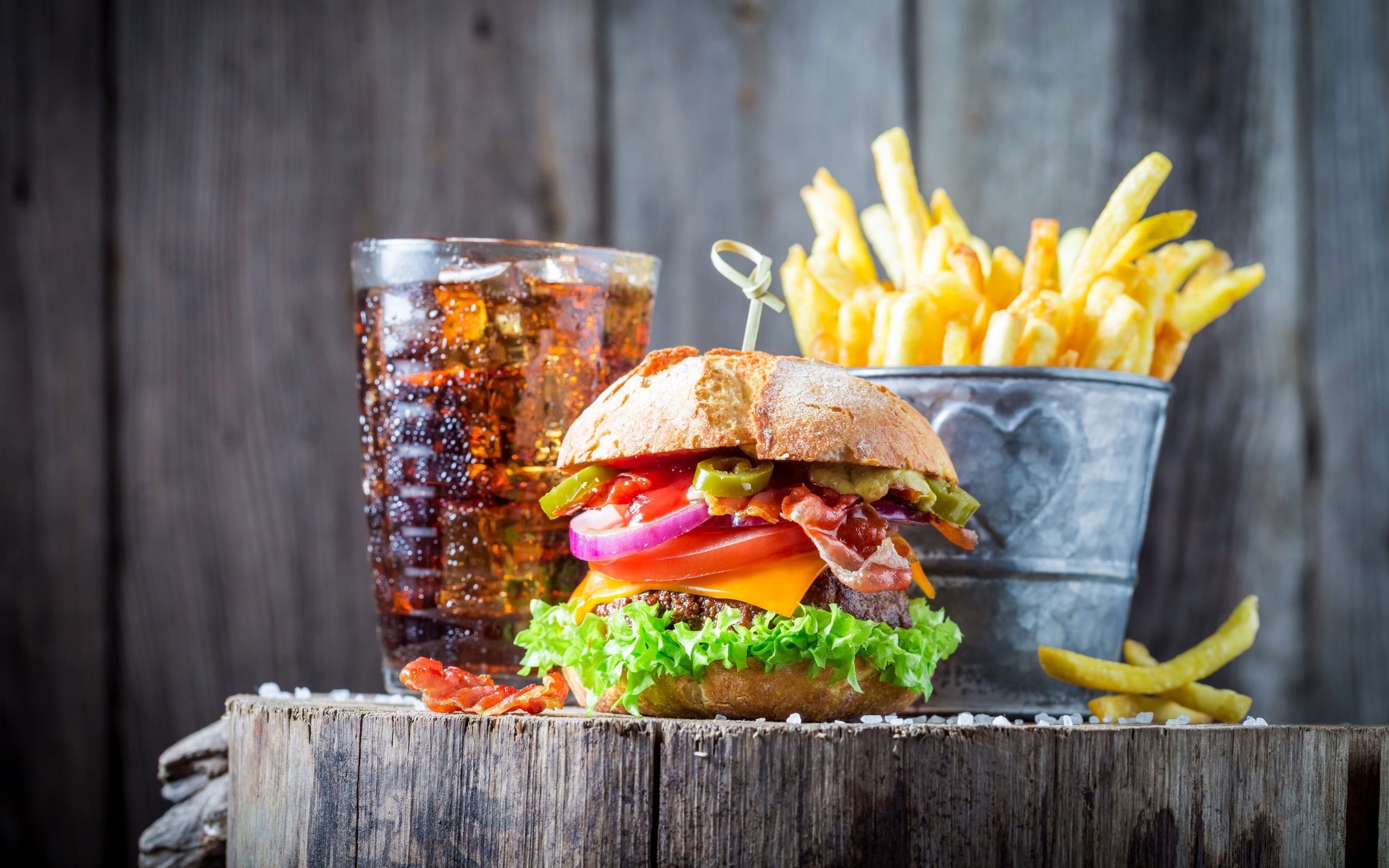 A burger and fries on top of wood - Foodie