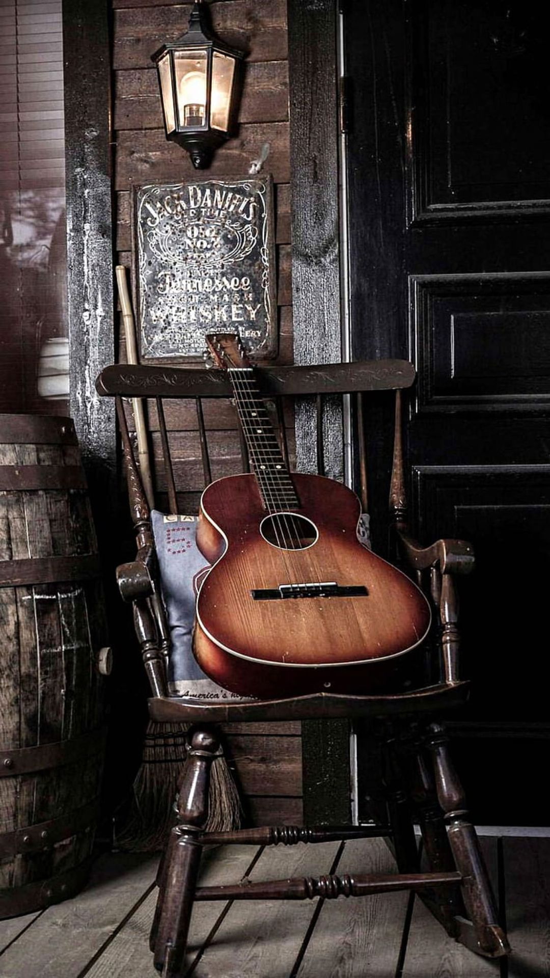 A guitar sitting on top of an old rocking chair - Guitar