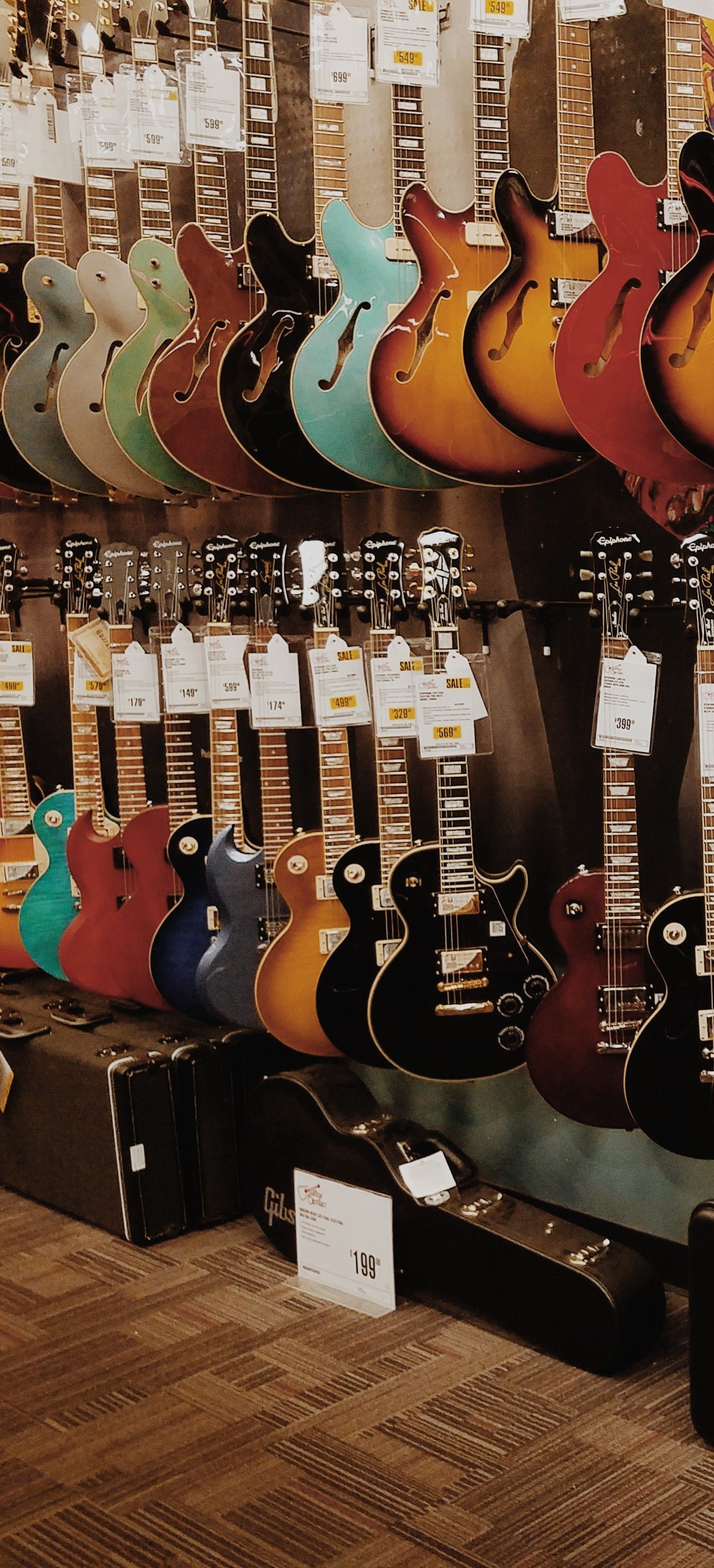 A store with many different types of guitars - Guitar
