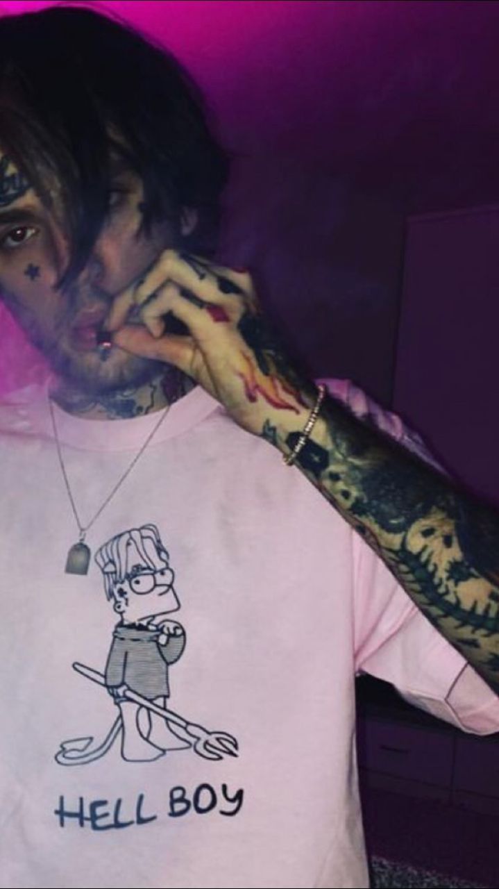 A man with tattoos wearing pink shirt and smoking - Lil Peep