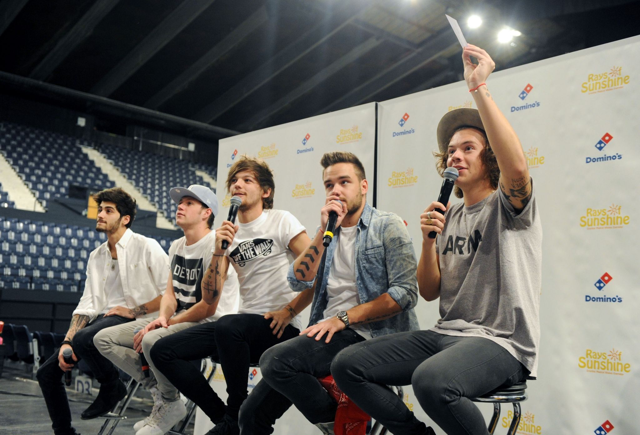 A group of young men sitting on chairs - One Direction