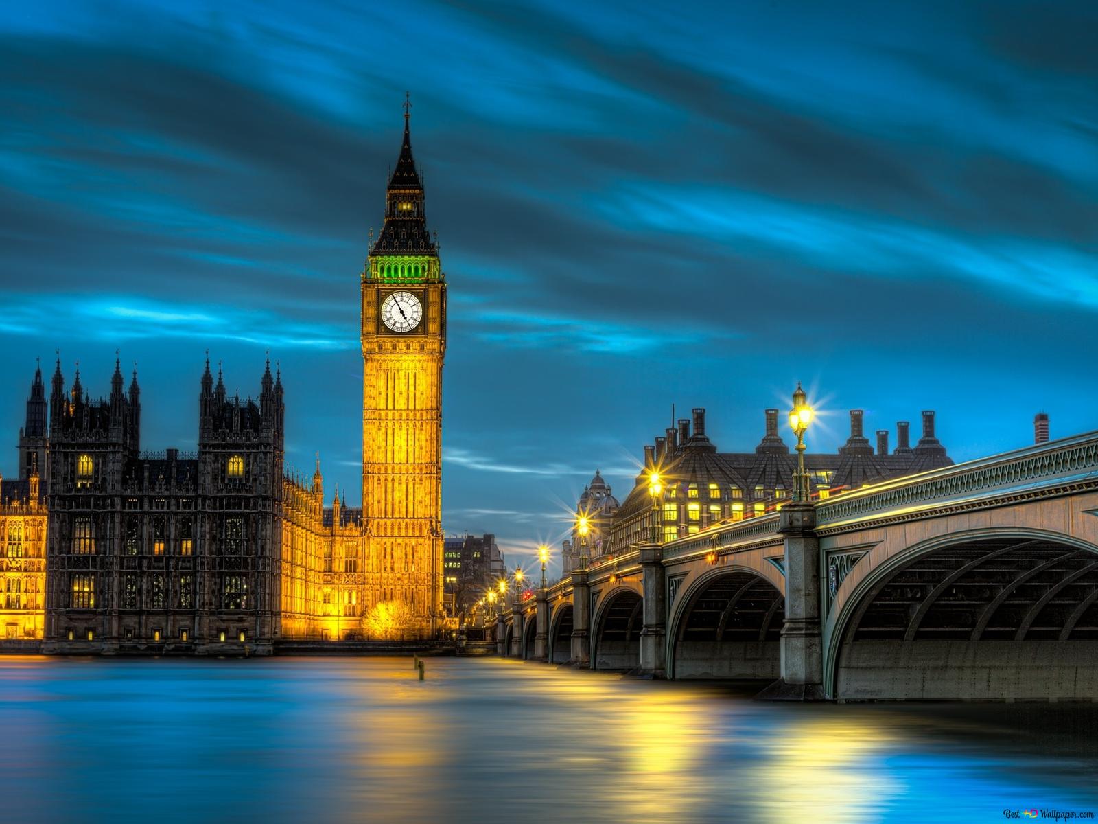 As a clock tower is lit up at night - London