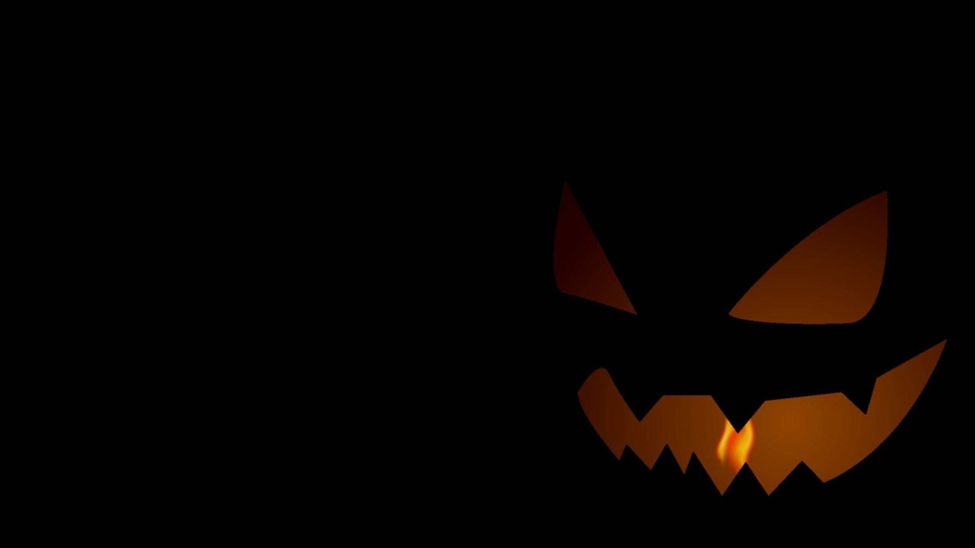 A pumpkin face in the dark - Halloween desktop