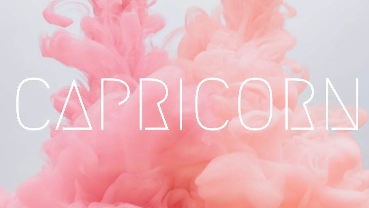 A pink and white image with the word capricorn - Capricorn
