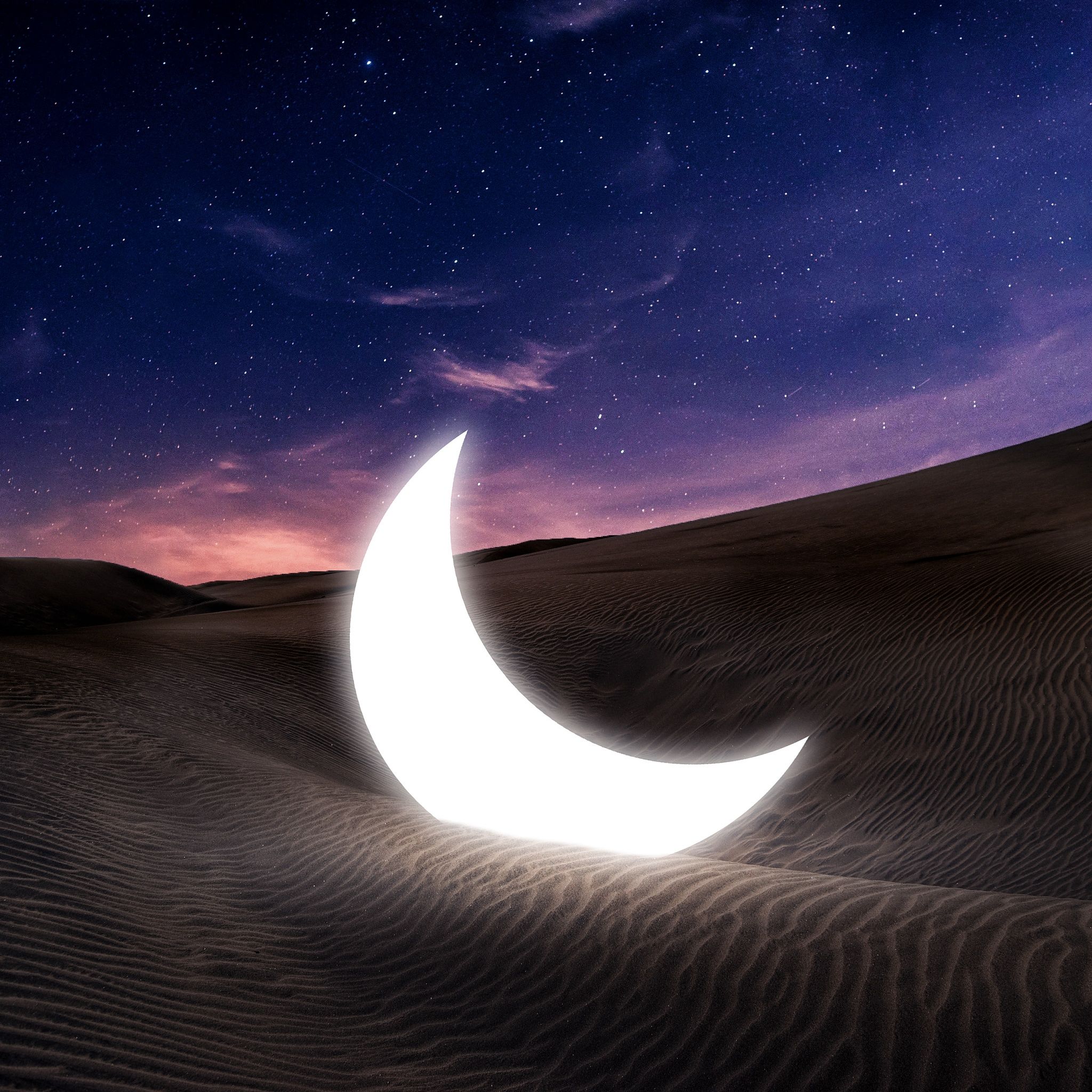 A crescent moon glows in the desert sky. - Moon