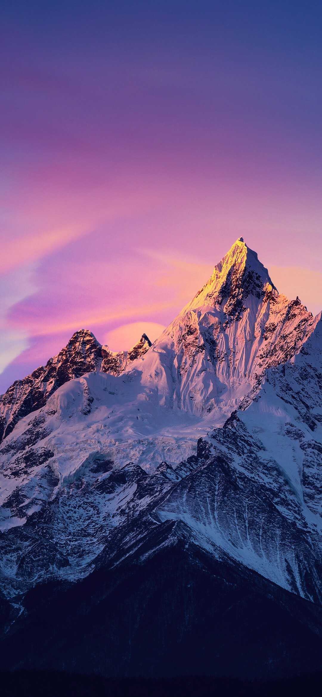 Snowy mountain peak with a purple sky - Mountain