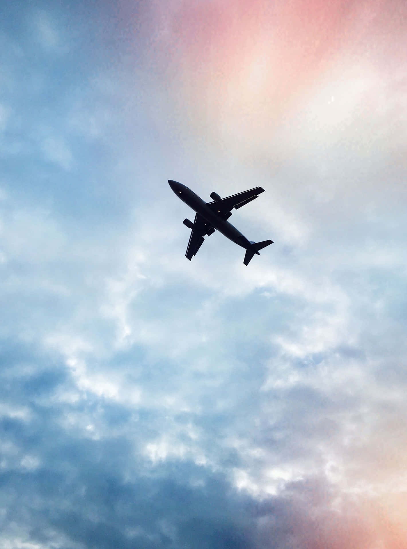 A plane flying through the sky with clouds - Travel, airplane