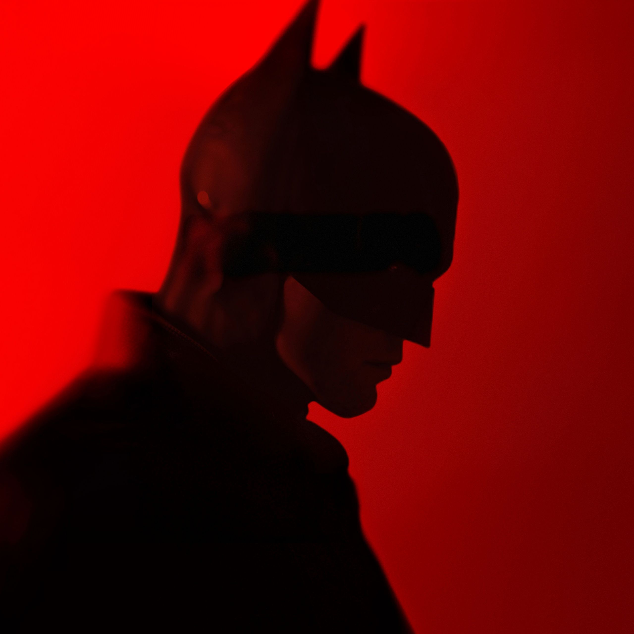 A batman in silhouette against red background - Batman