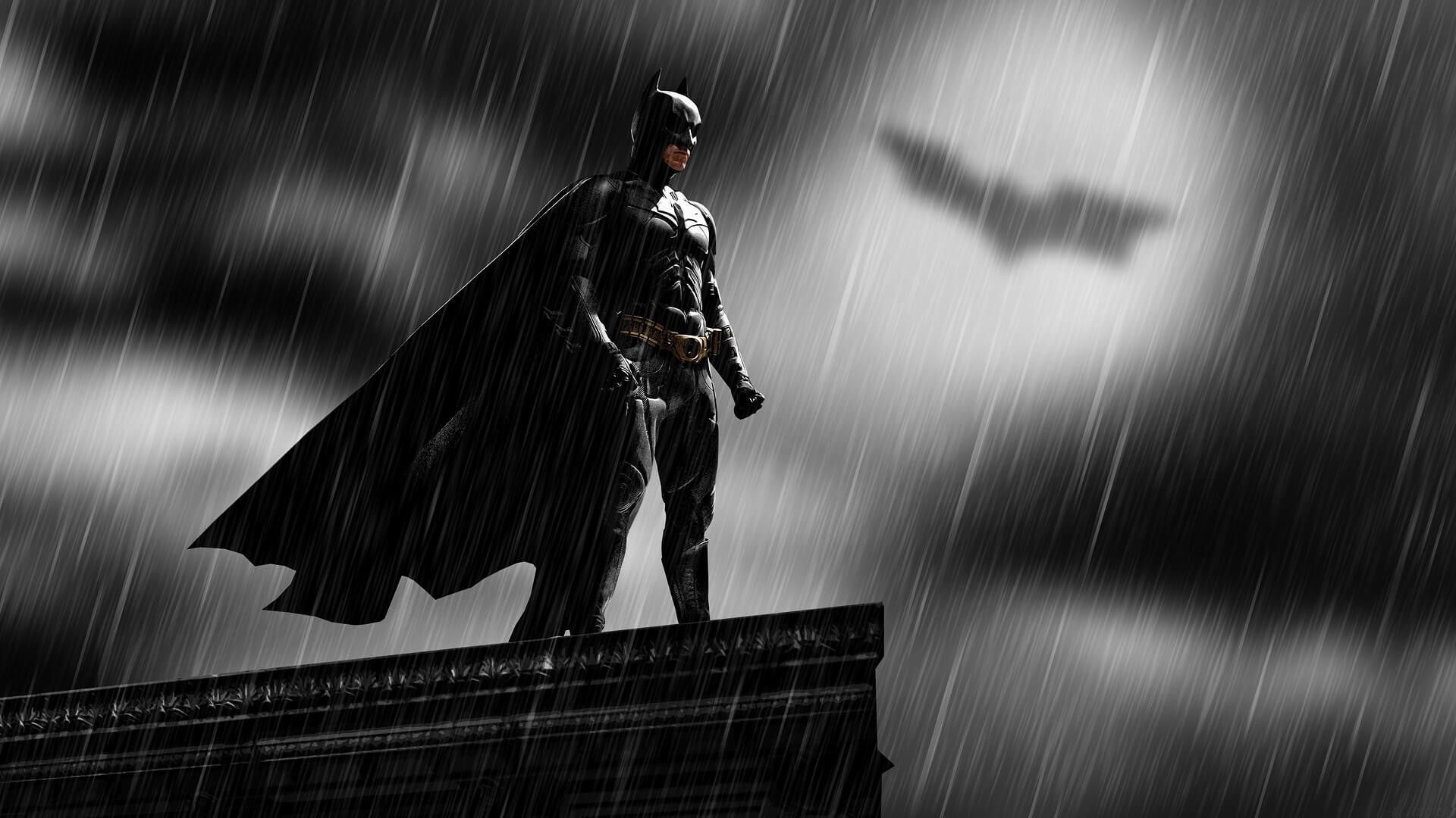 Batman standing on a ledge in the rain - Batman