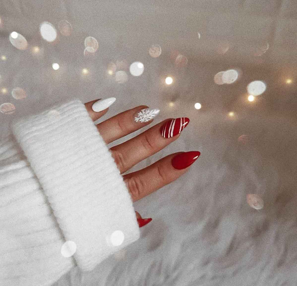 A woman's hand with red and white Christmas nails. - Nails