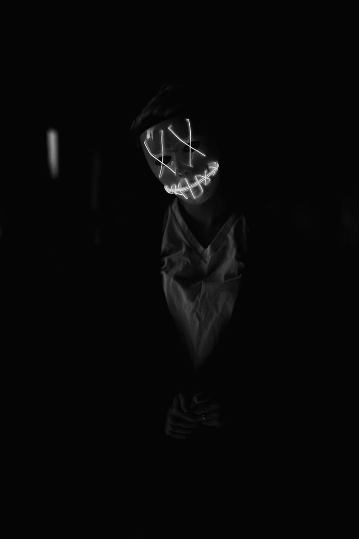 A black and white photo of the face in darkness - Black