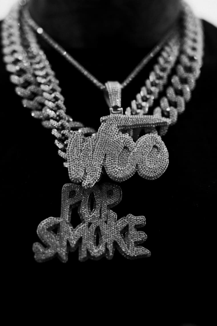 A close up of some jewelry with the word pop smoke on it - Pop Smoke