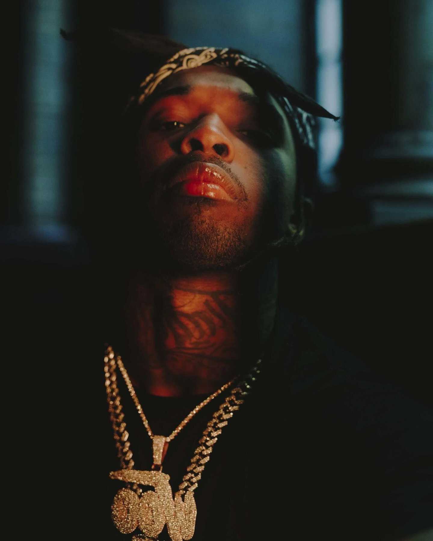 A man wearing gold chains and necklaces - Pop Smoke