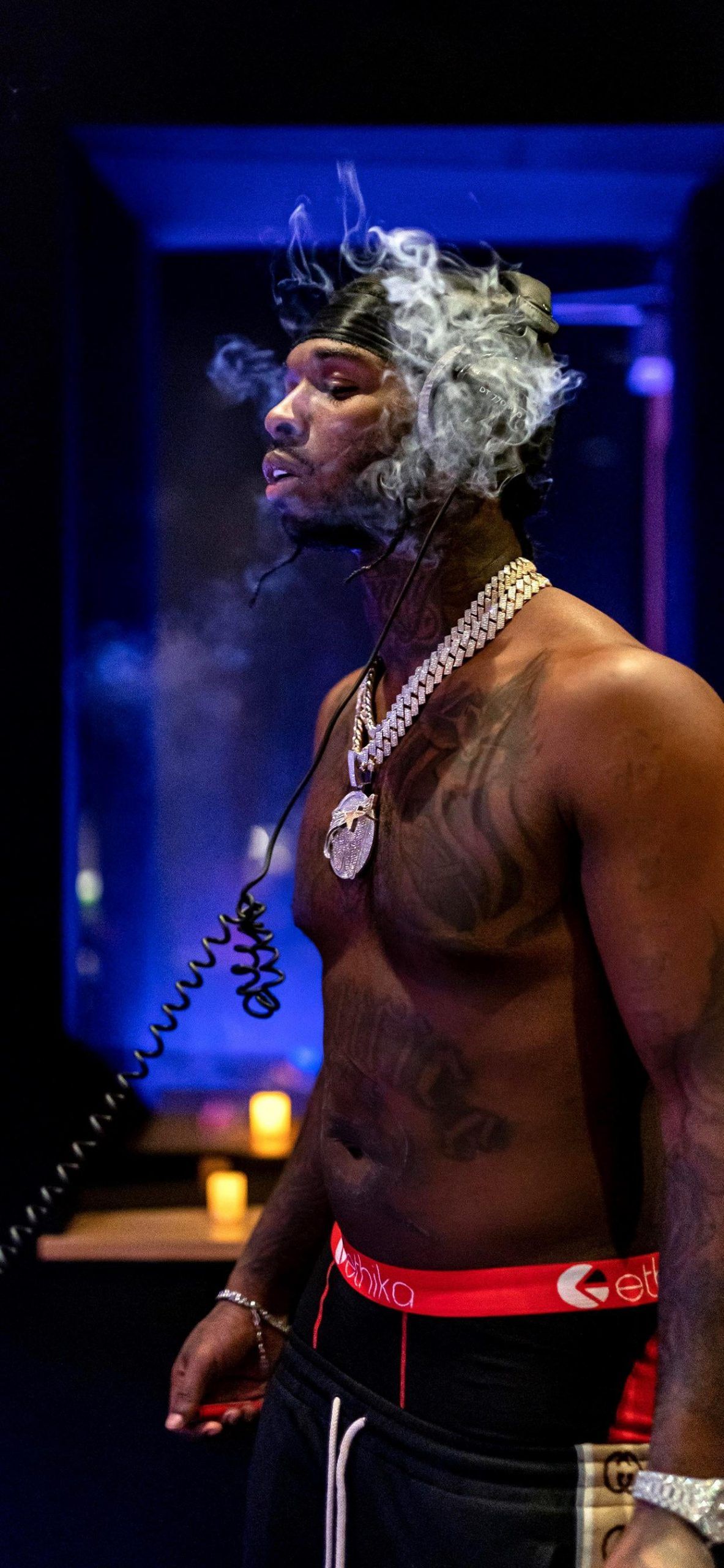 A man smoking on the phone in his underwear - Pop Smoke