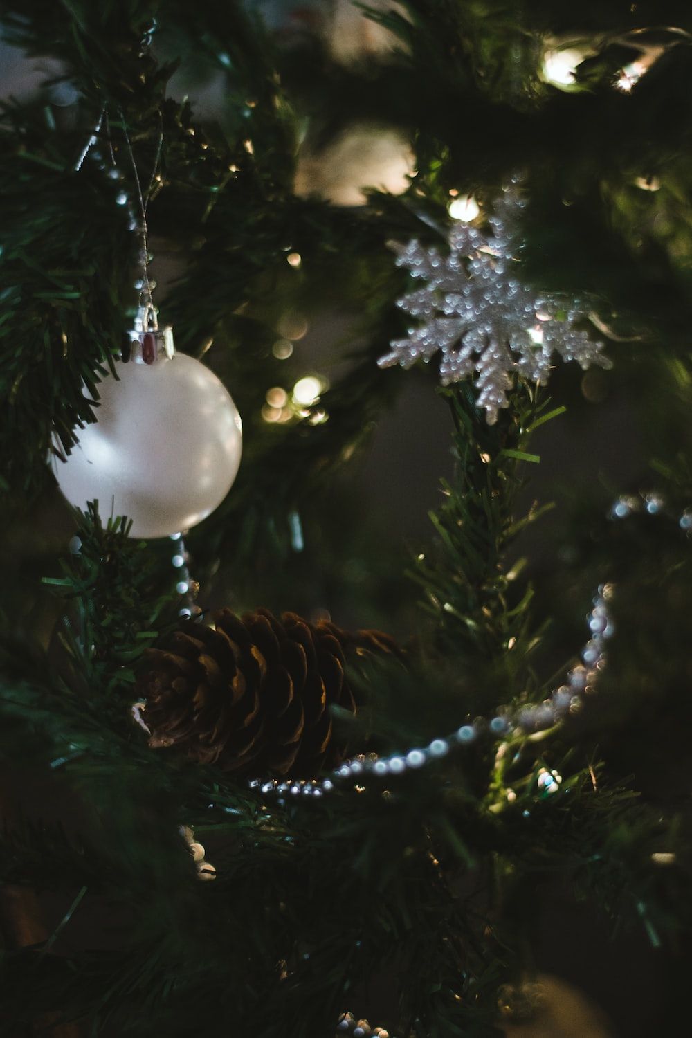 white christmas bauble on green christmas tree photo