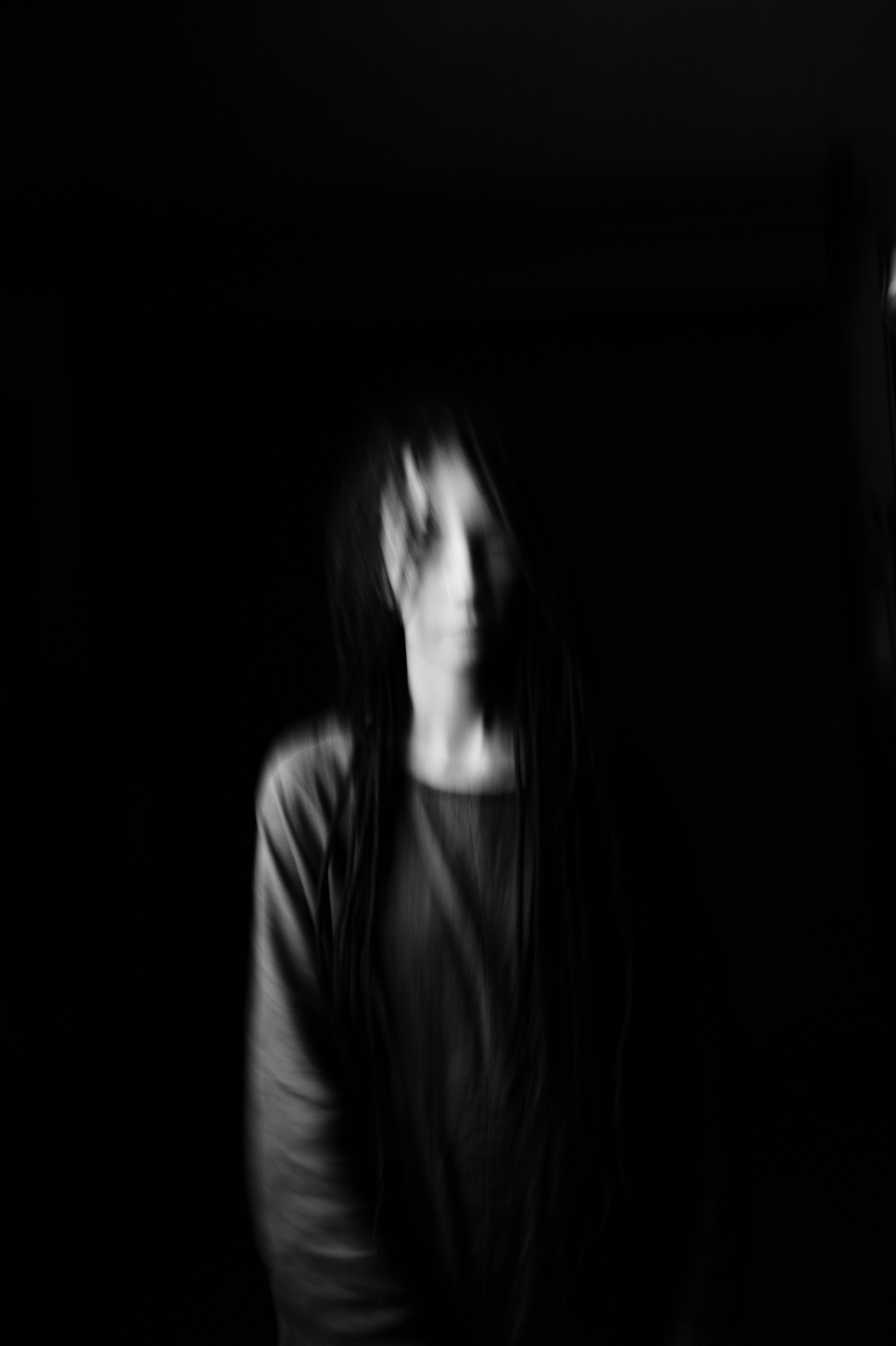 A woman with long hair in a black and white photo. - Black, black and white, dark phone, blurry
