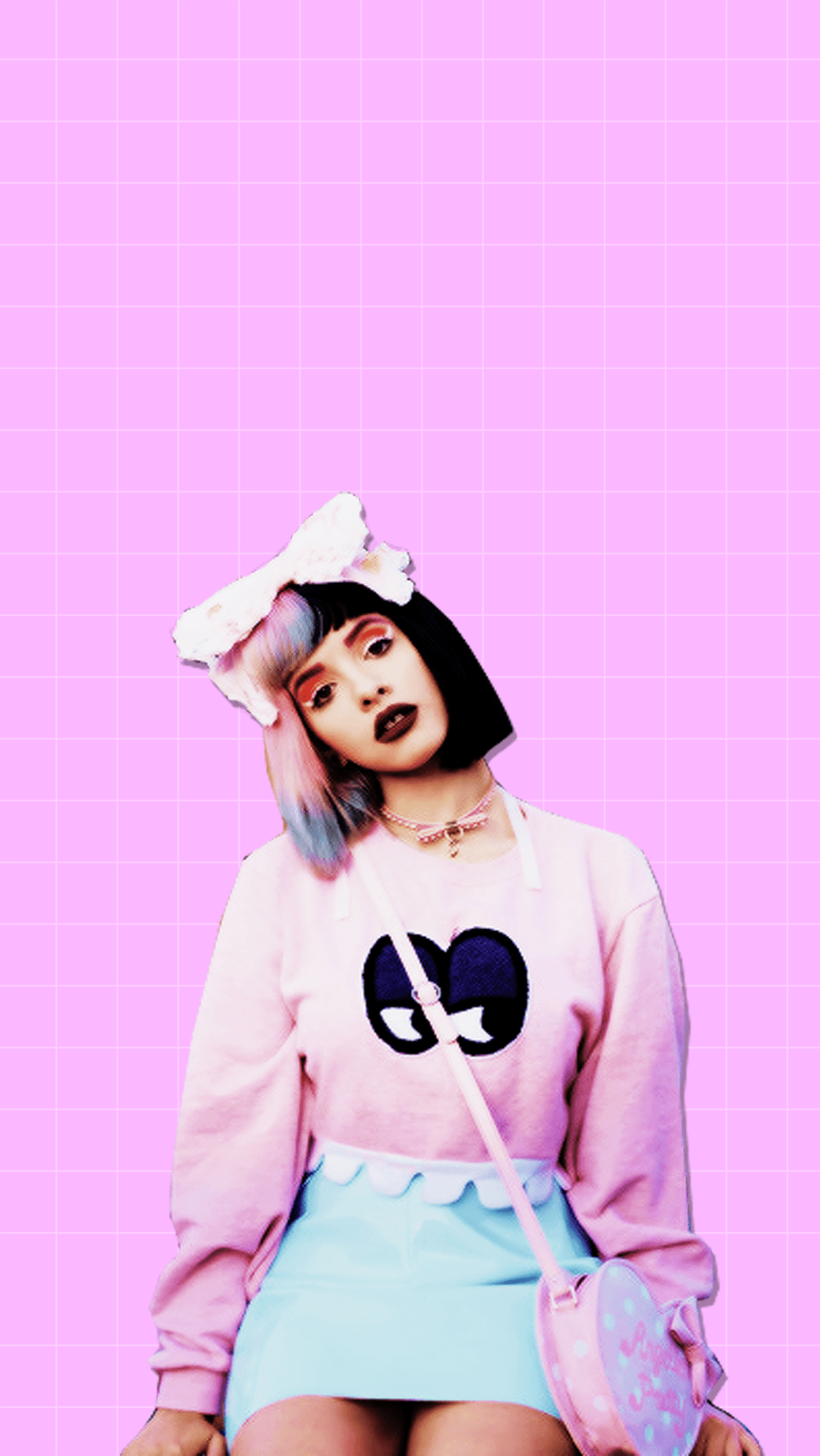 A woman in pink and blue clothing sitting on the ground - Melanie Martinez