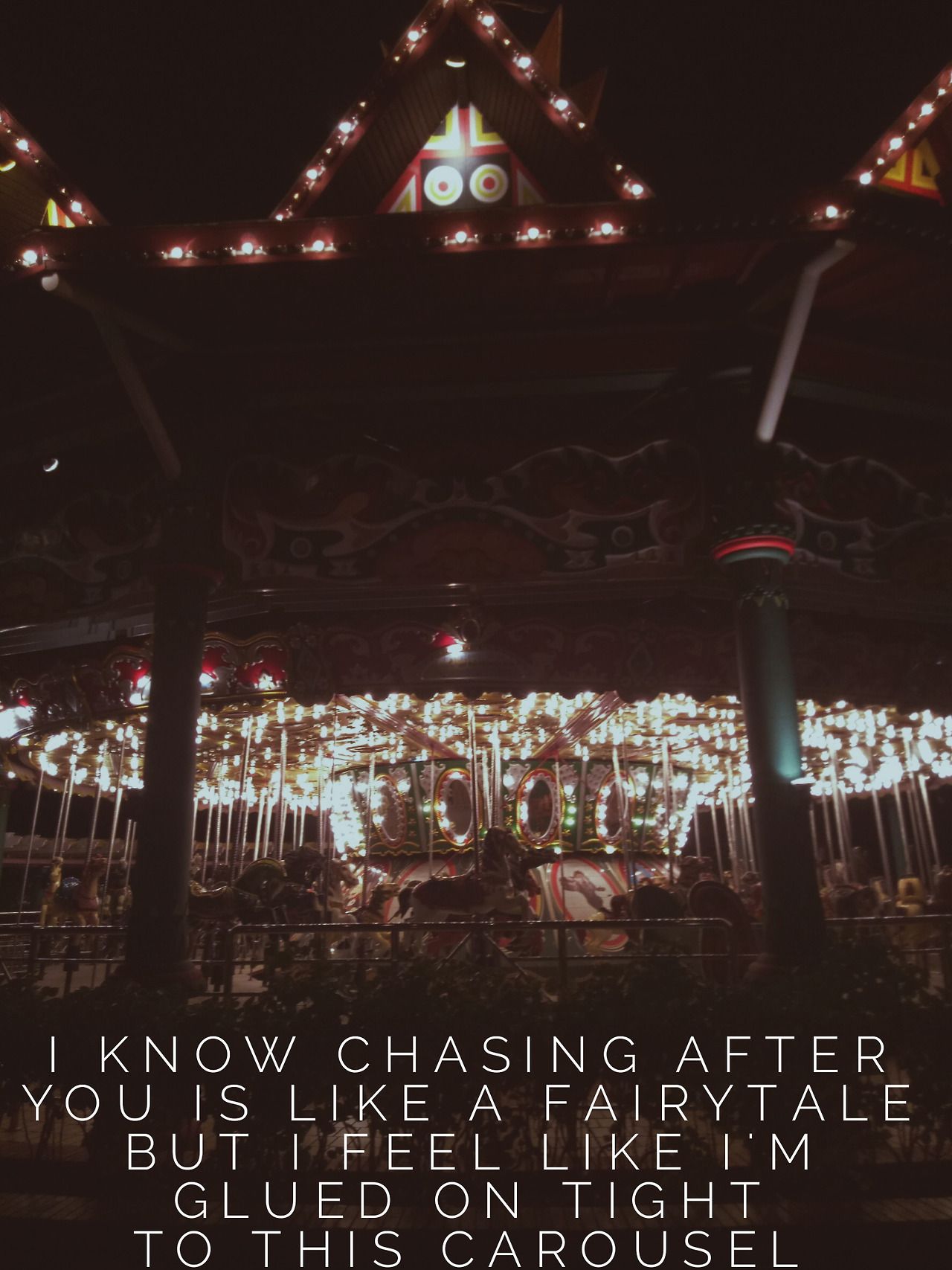 A carousel with lights on it at night - Melanie Martinez
