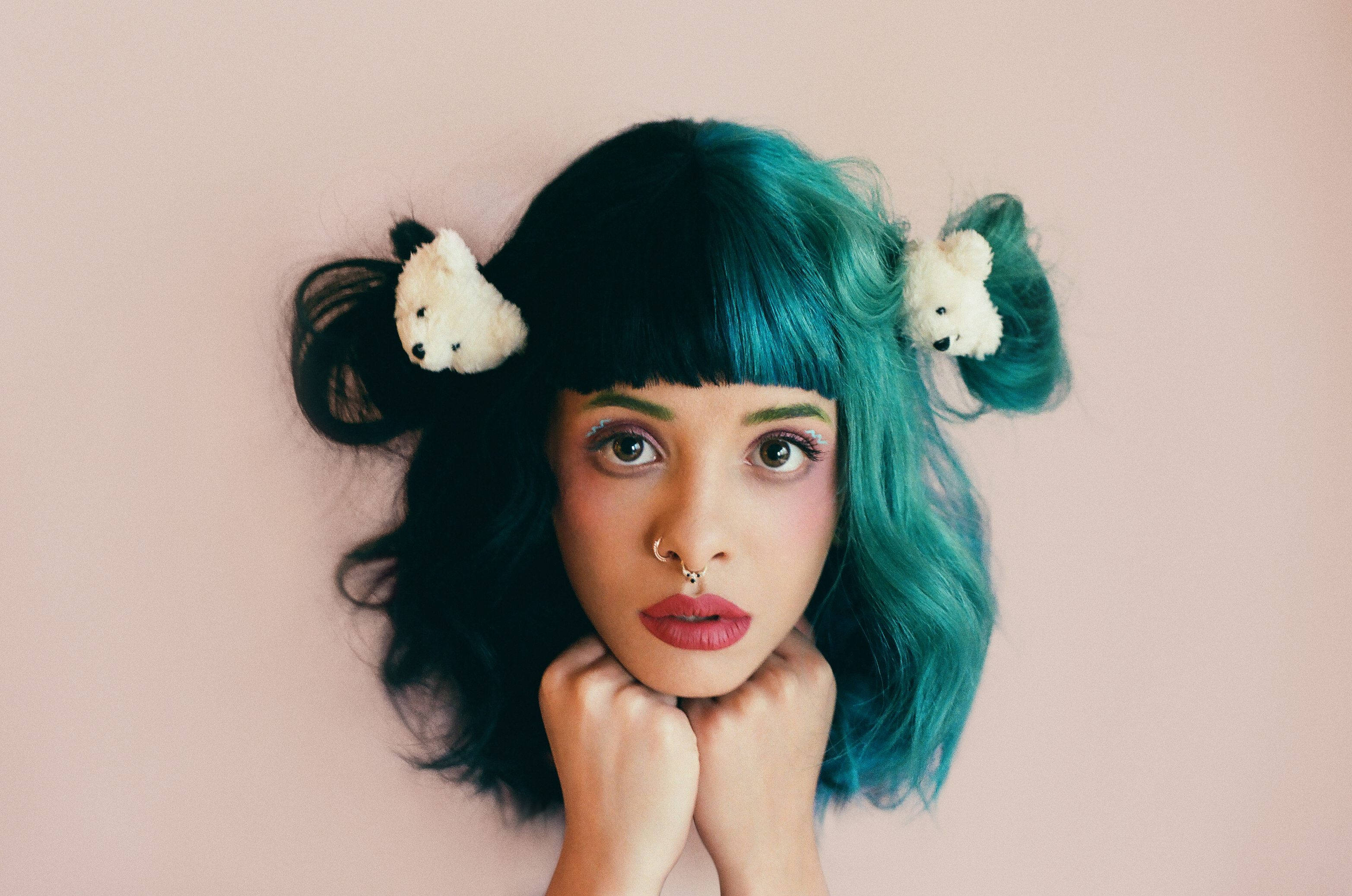 A woman with green hair and two bears on her head - Melanie Martinez