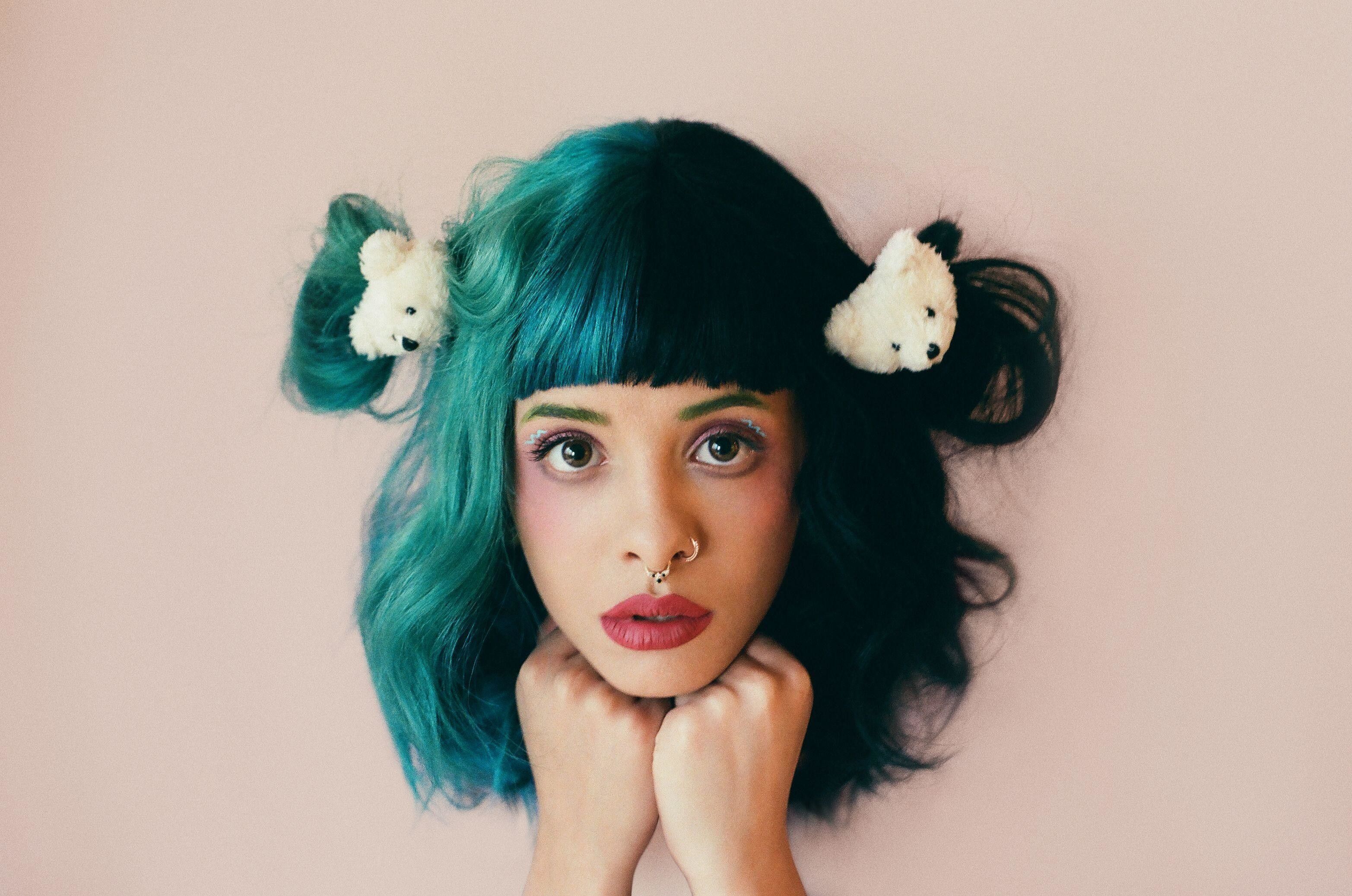 A woman with green hair and teddy bear buns - Melanie Martinez