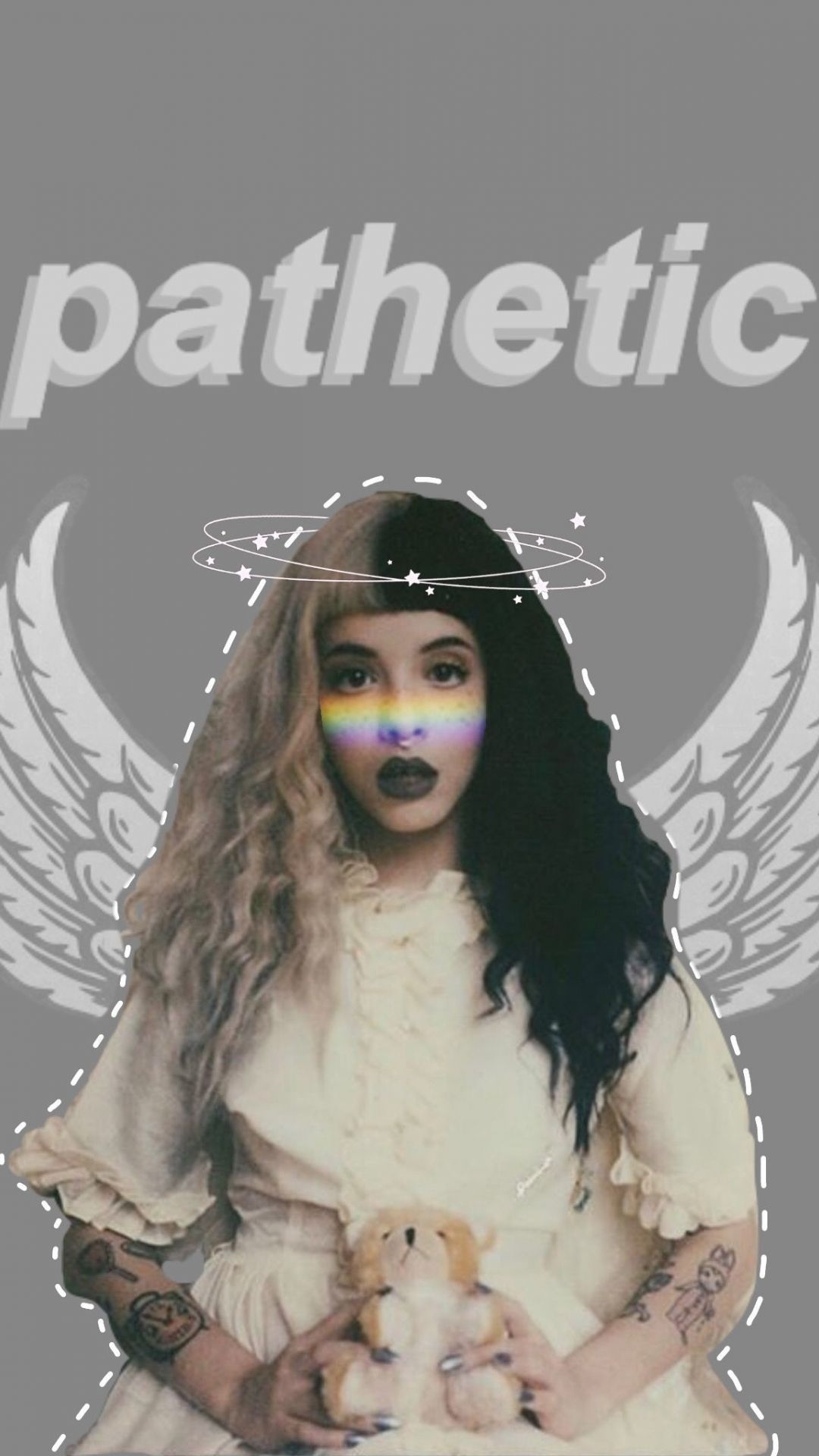 A woman with tattoos and piercings holding teddy bear - Melanie Martinez