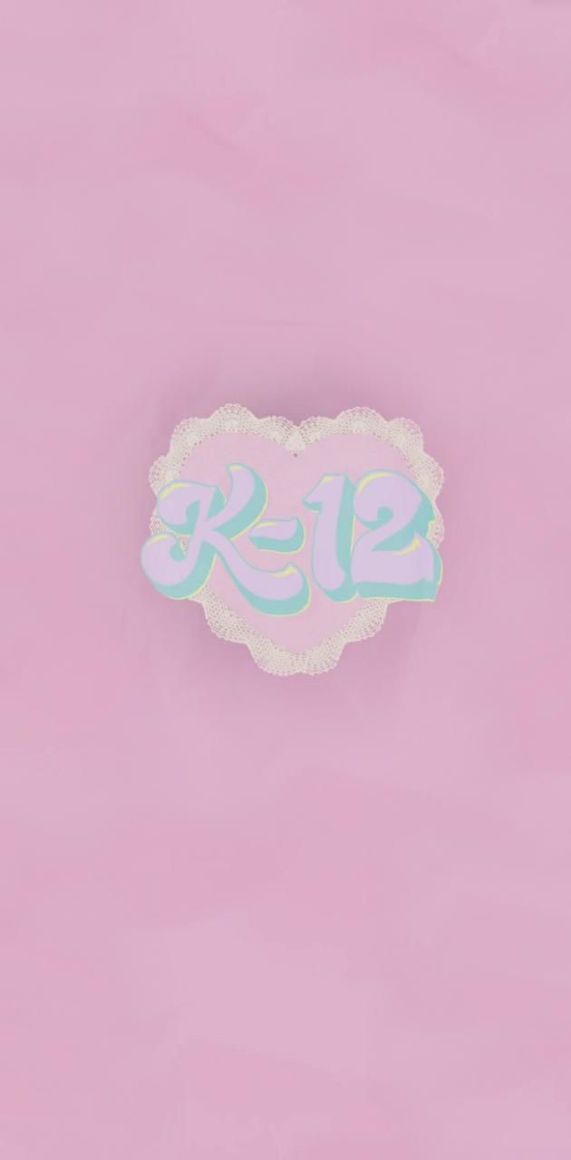 A sticker that says K-12 on a pink background - Melanie Martinez