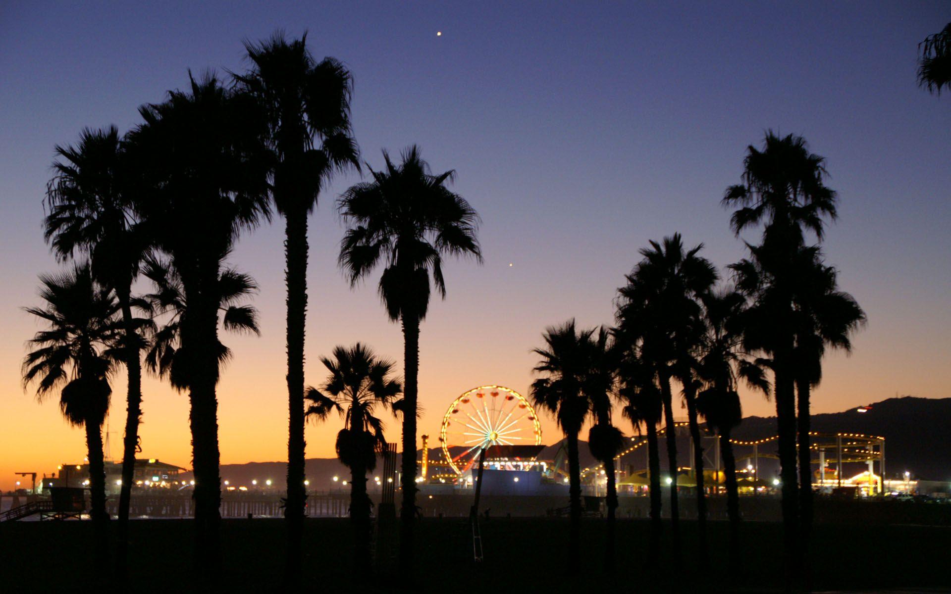 The Santa Monica Pier is a popular tourist destination with a Ferris wheel and other attractions. - California