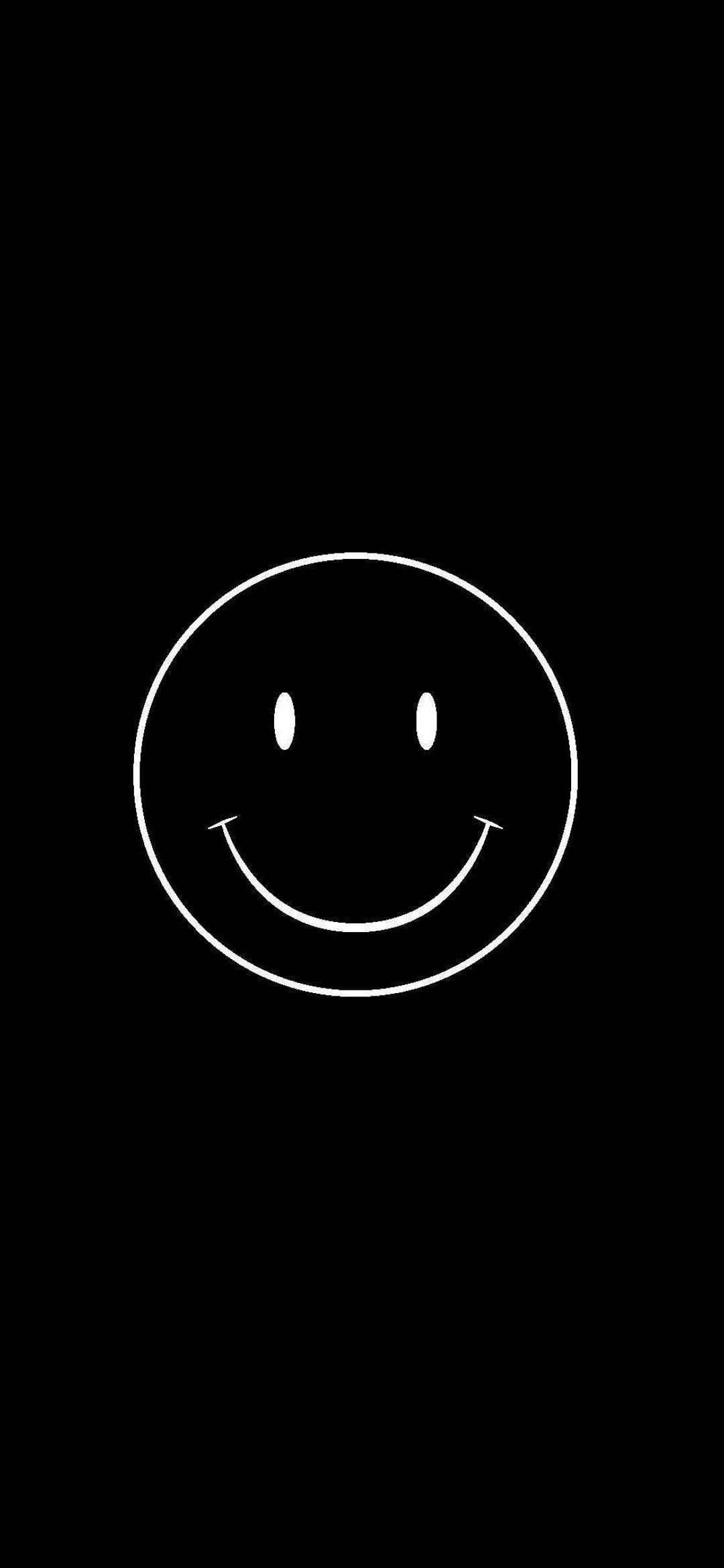 A white oval with a smiley face on a black background - Smile