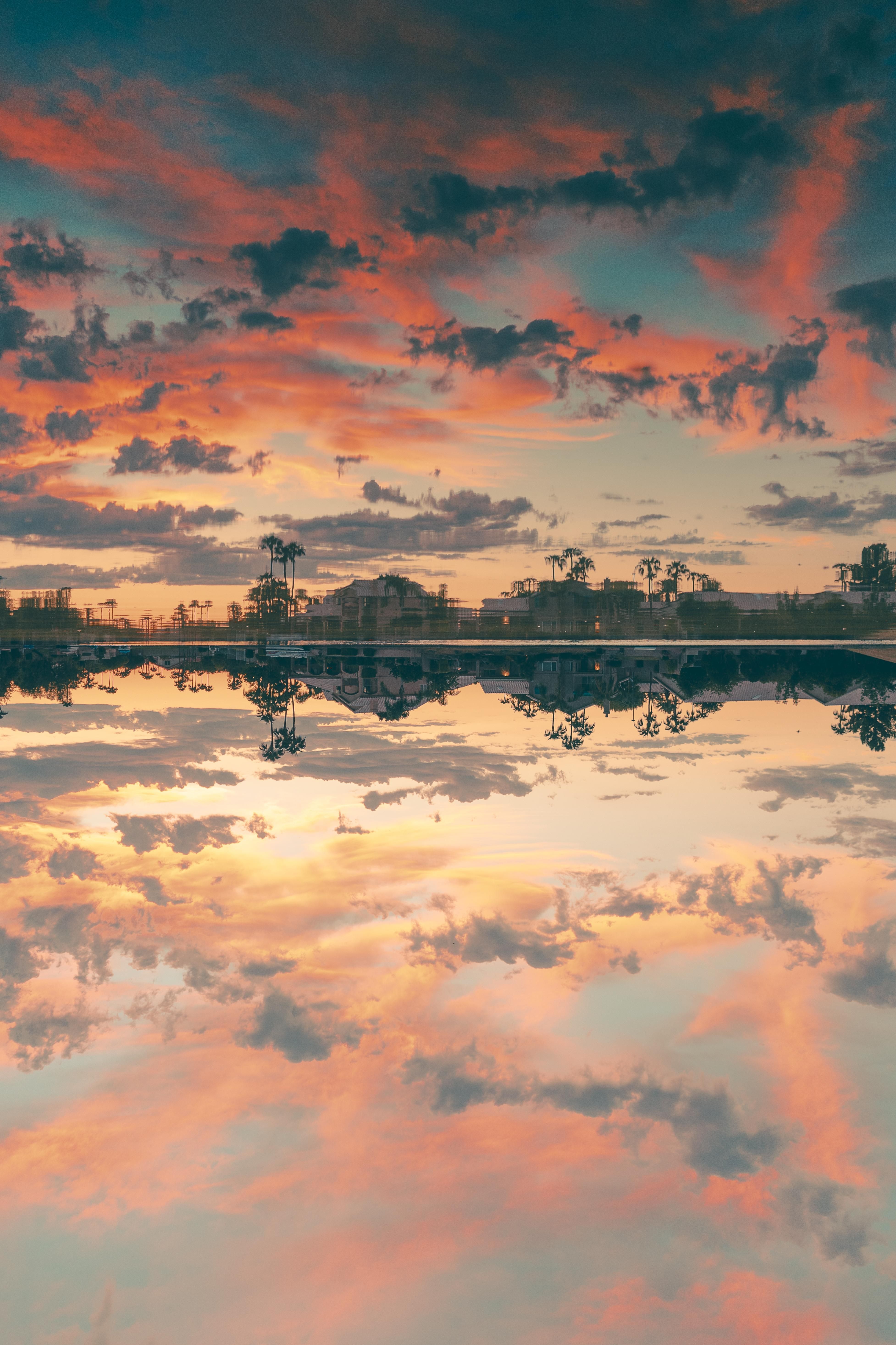 A sunset over the water with clouds in it - Sunrise, lake