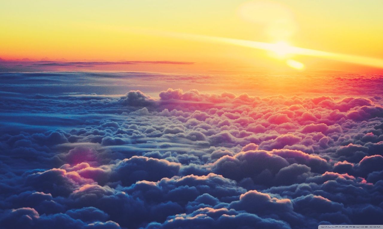 The sun is setting over a sea of clouds - Sunrise