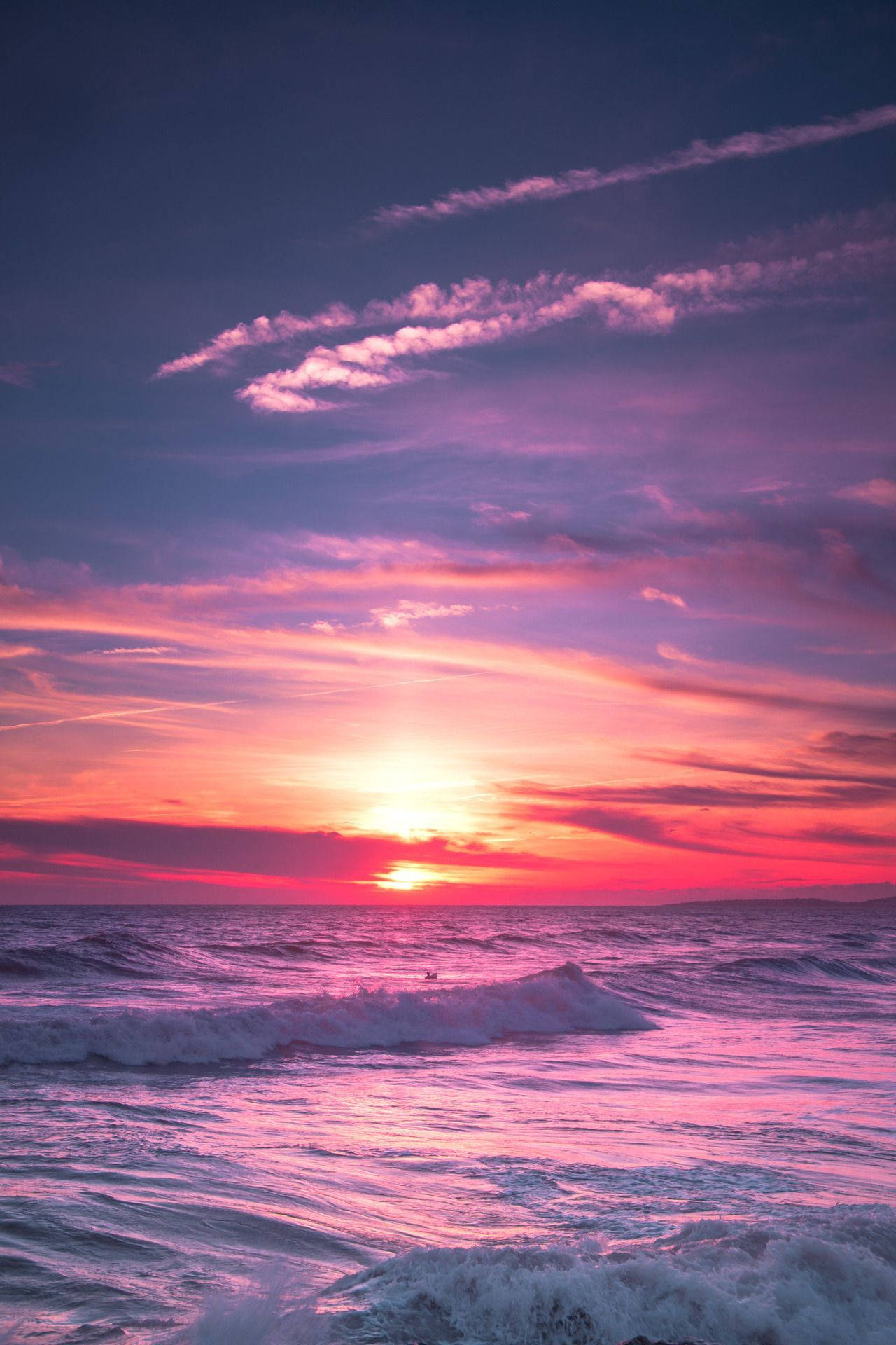 A beautiful sunset over the ocean with pink and purple hues - Sunrise, Florida