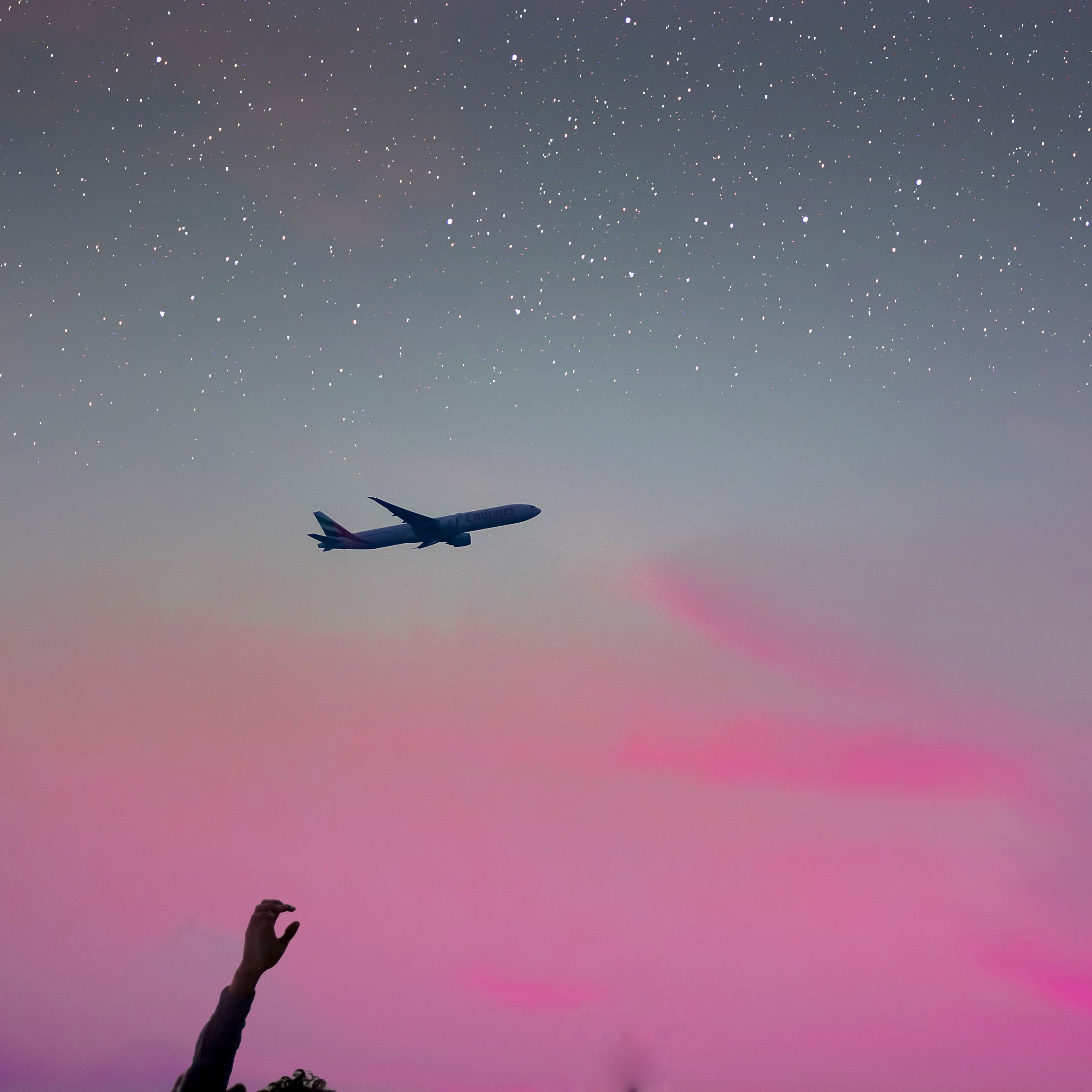 A plane flying in the sky at night - Travel