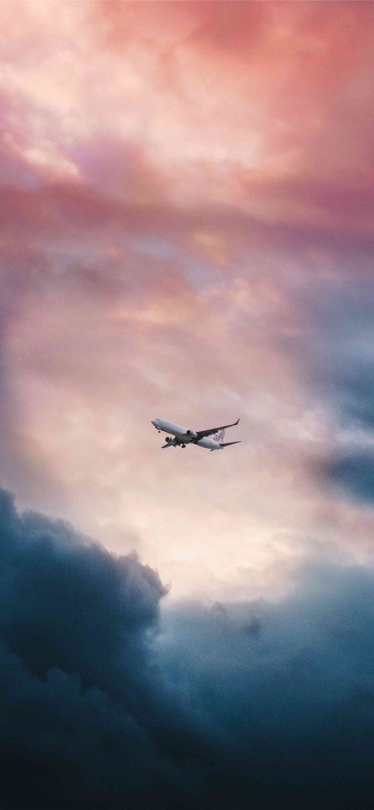 A plane flying in the sky with a beautiful sunset - Travel, airplane