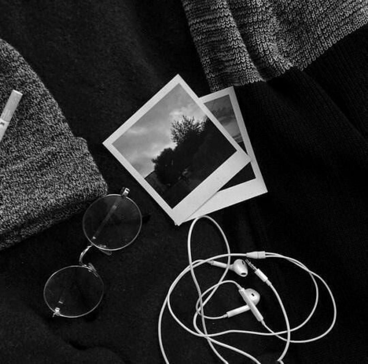 A black and white photo of an ipod, glasses earphones - Black, white, black and white