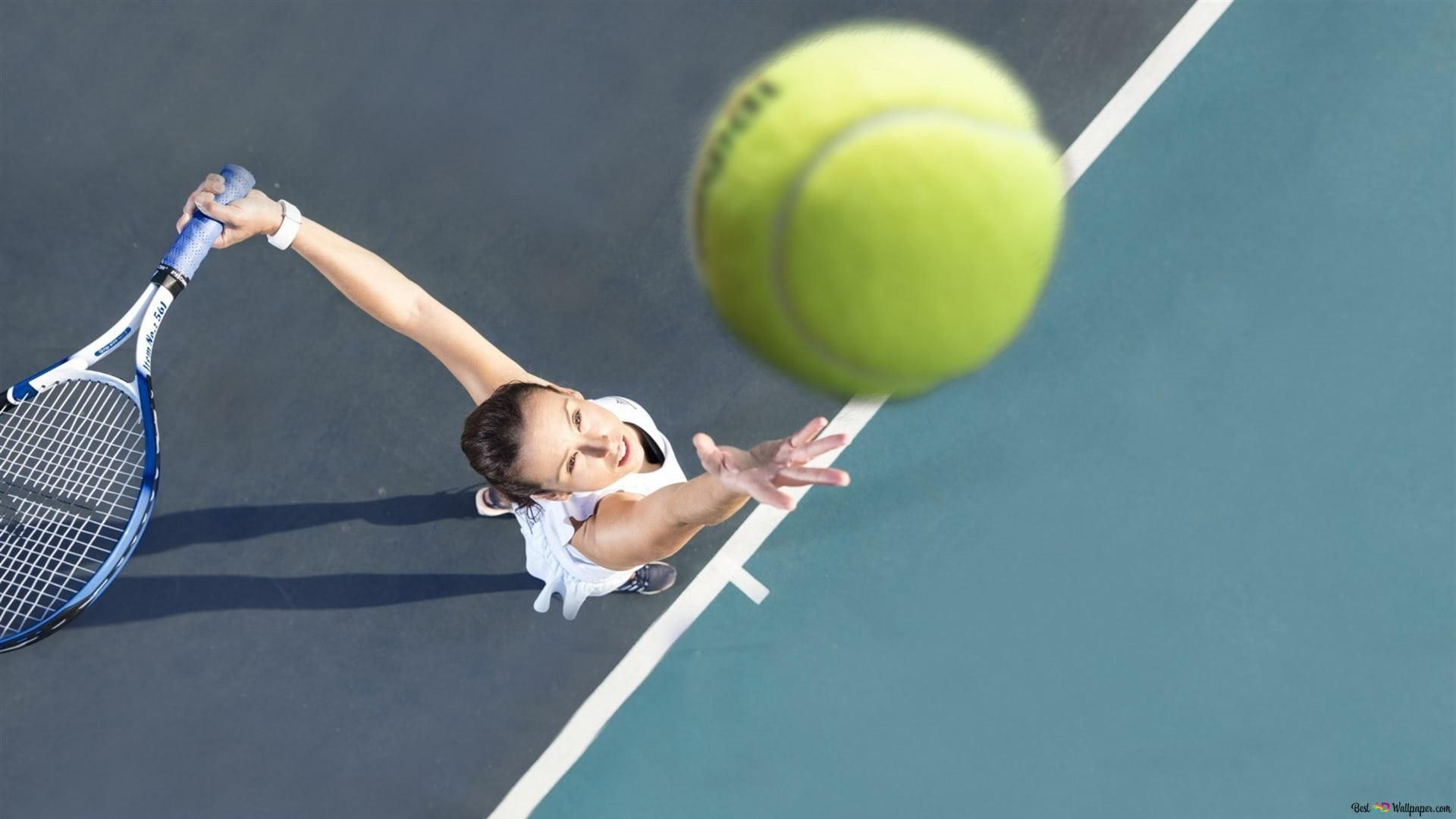 A woman is playing tennis on the court - Tennis