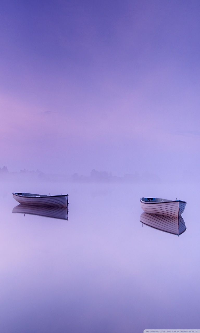Two boats on a lake in the morning mist - Calming