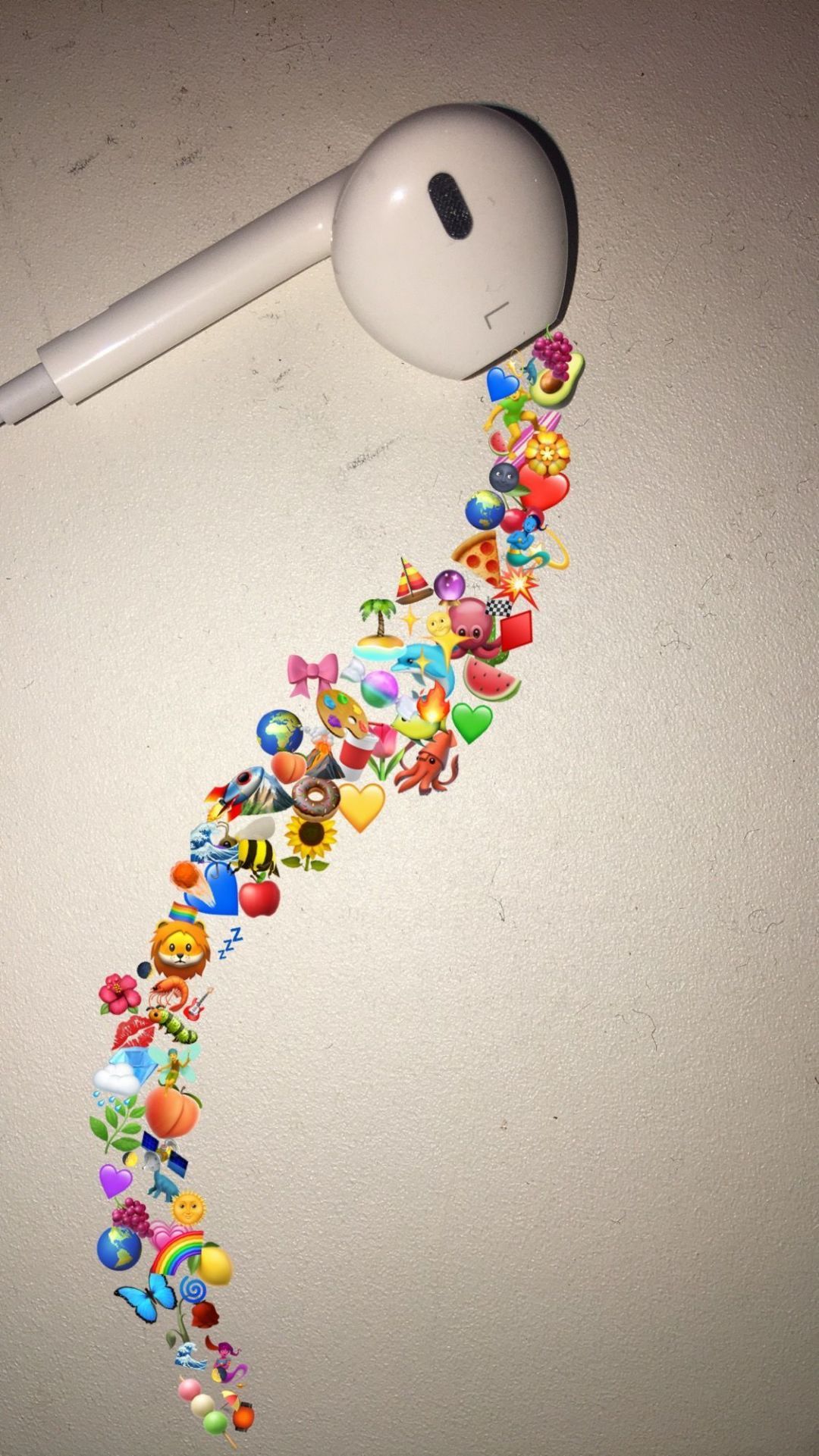 An iPhone headset with colorful stickers on it. - Emoji