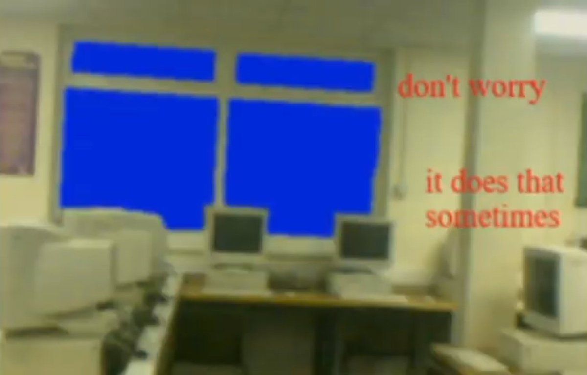 A computer lab with a blue filter and the words 