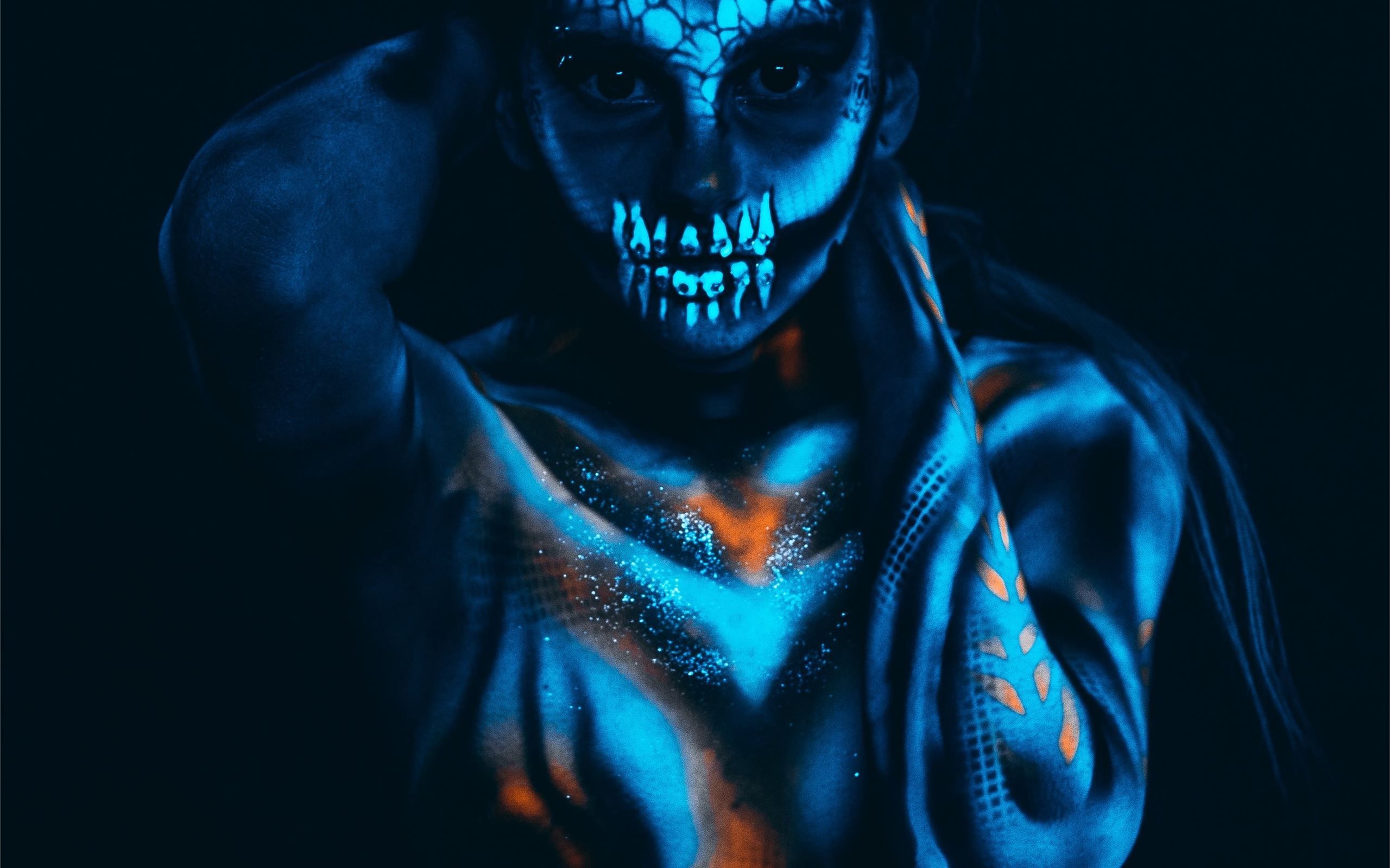 A man with glowing face paint and a hoodie - Skull