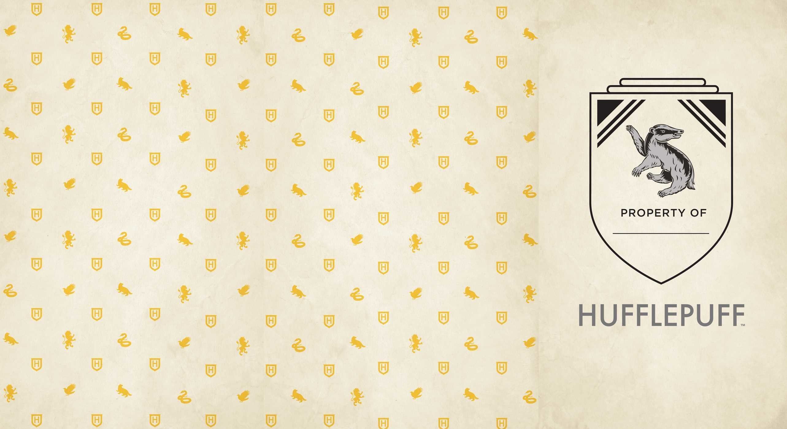 Harry Potter Hufflepuff wallpaper with the Hufflepuff symbol on a beige background - Hufflepuff