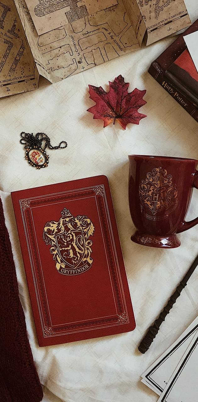 A Gryffindor journal, wand, marauder's map, and a Gryffindor coffee mug - Gryffindor