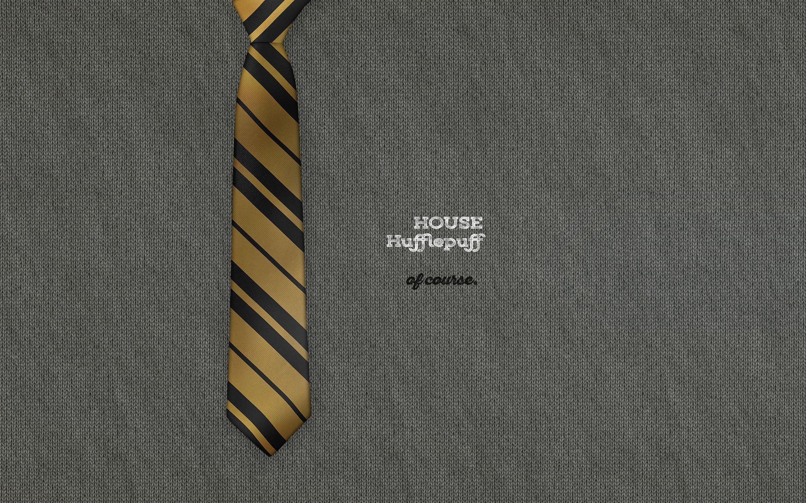A gold and black striped tie on a grey suit. - Hufflepuff