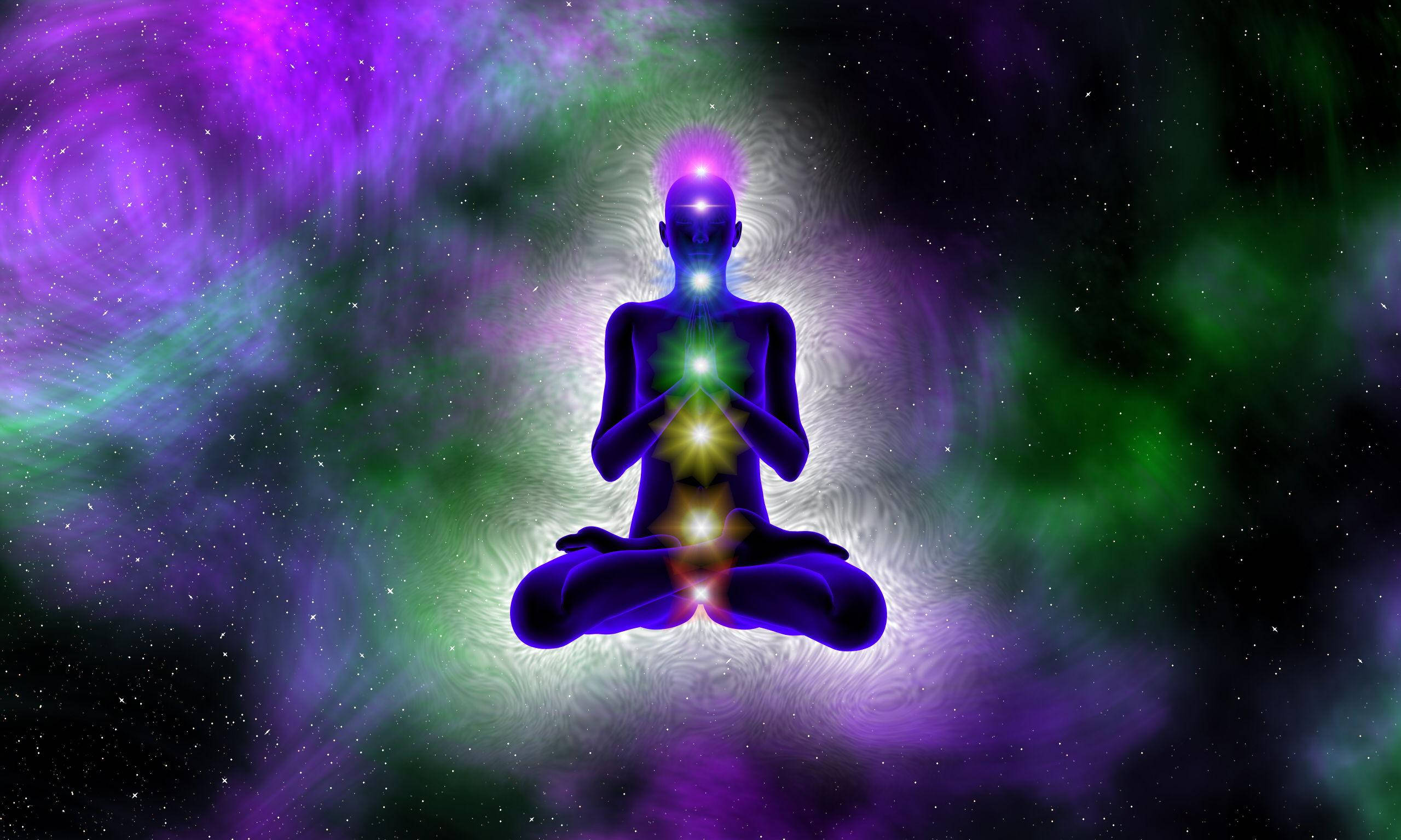 A person in meditation with purple and green light - Spiritual
