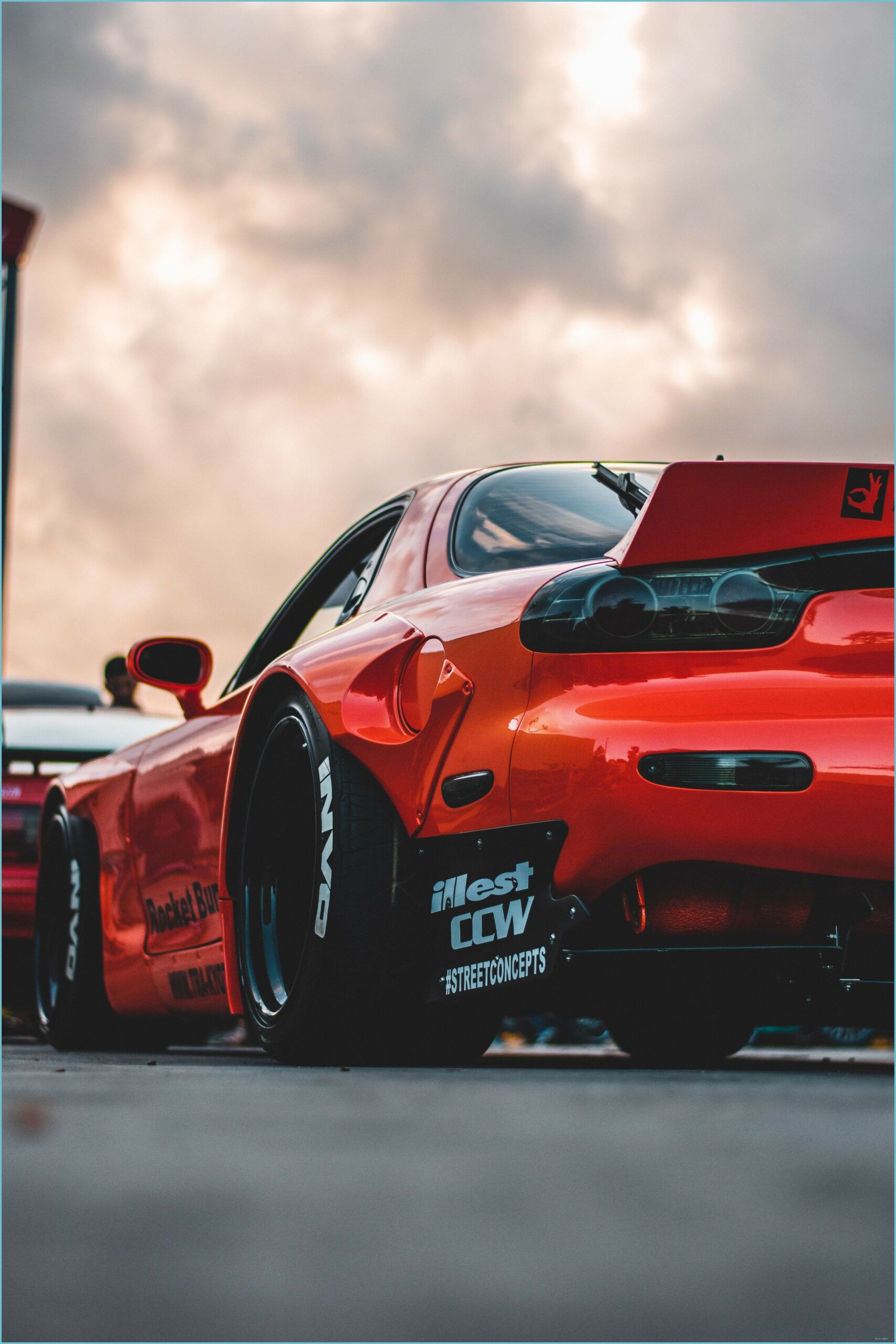 A red sports car parked in front of other cars - Cars