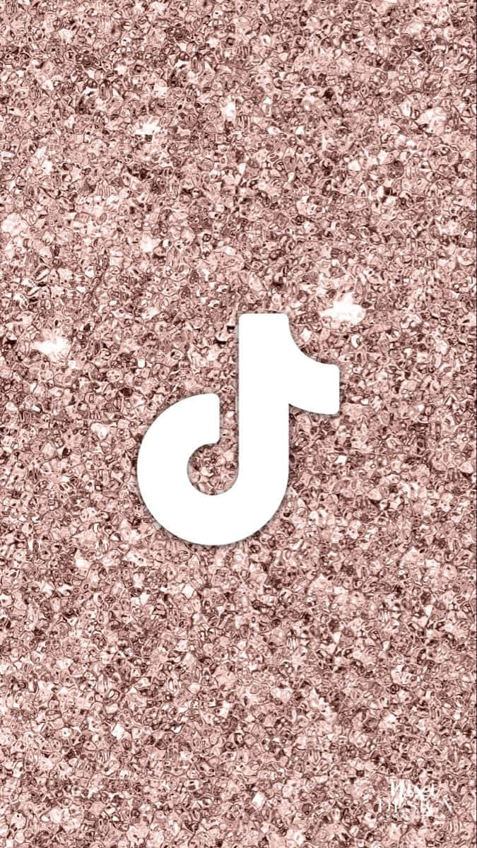 A pink glittery background with the letter t - TikTok