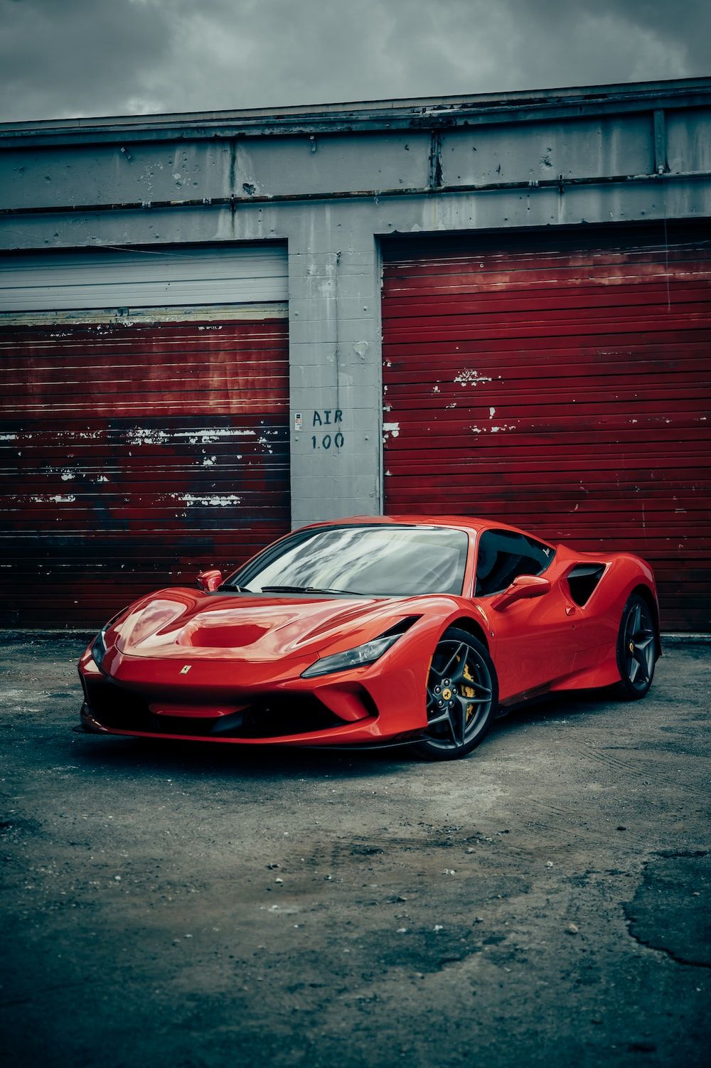 A red sports car parked in front of garage - Cars