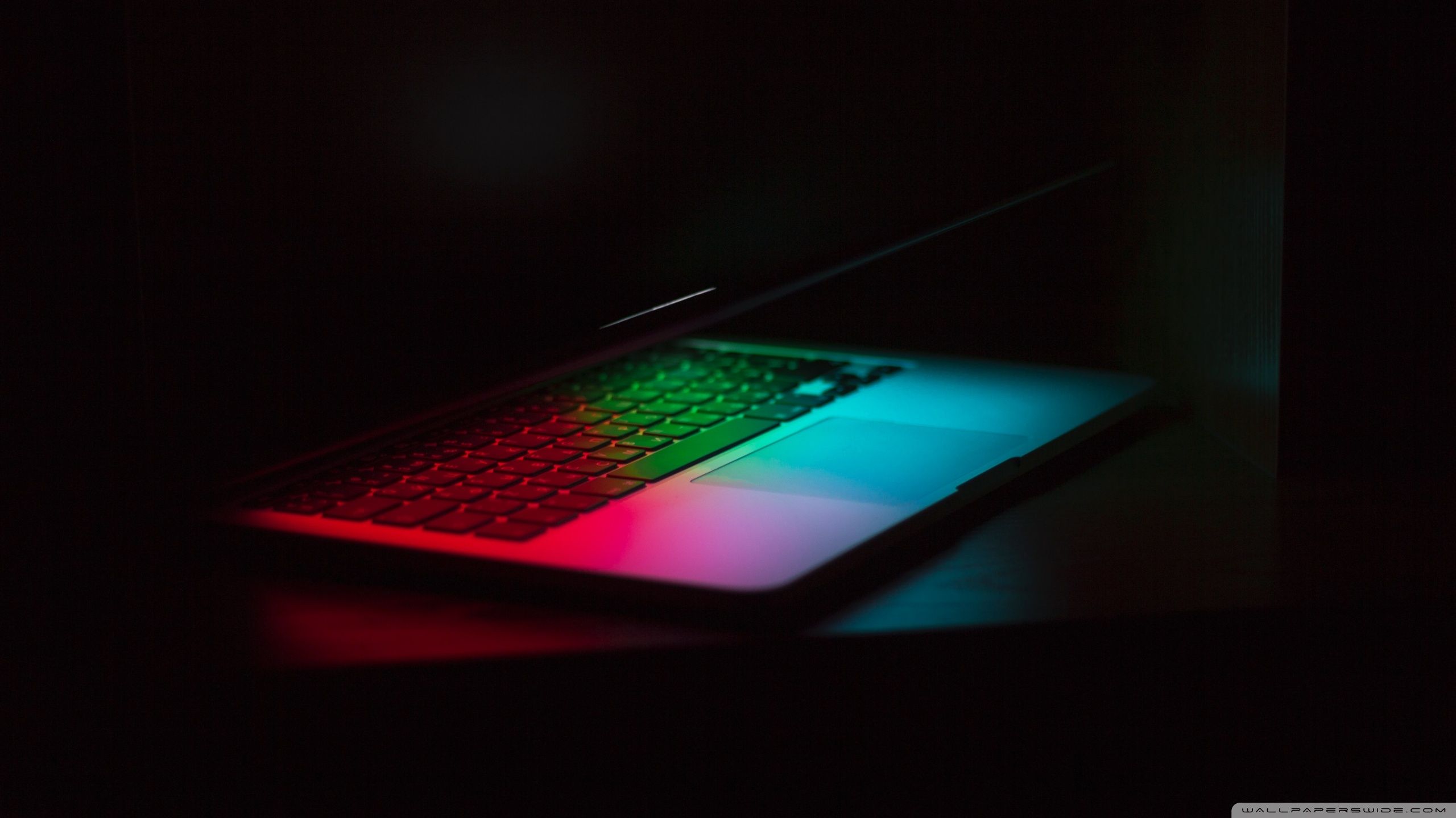 A laptop with a colorful keyboard in the dark - Laptop