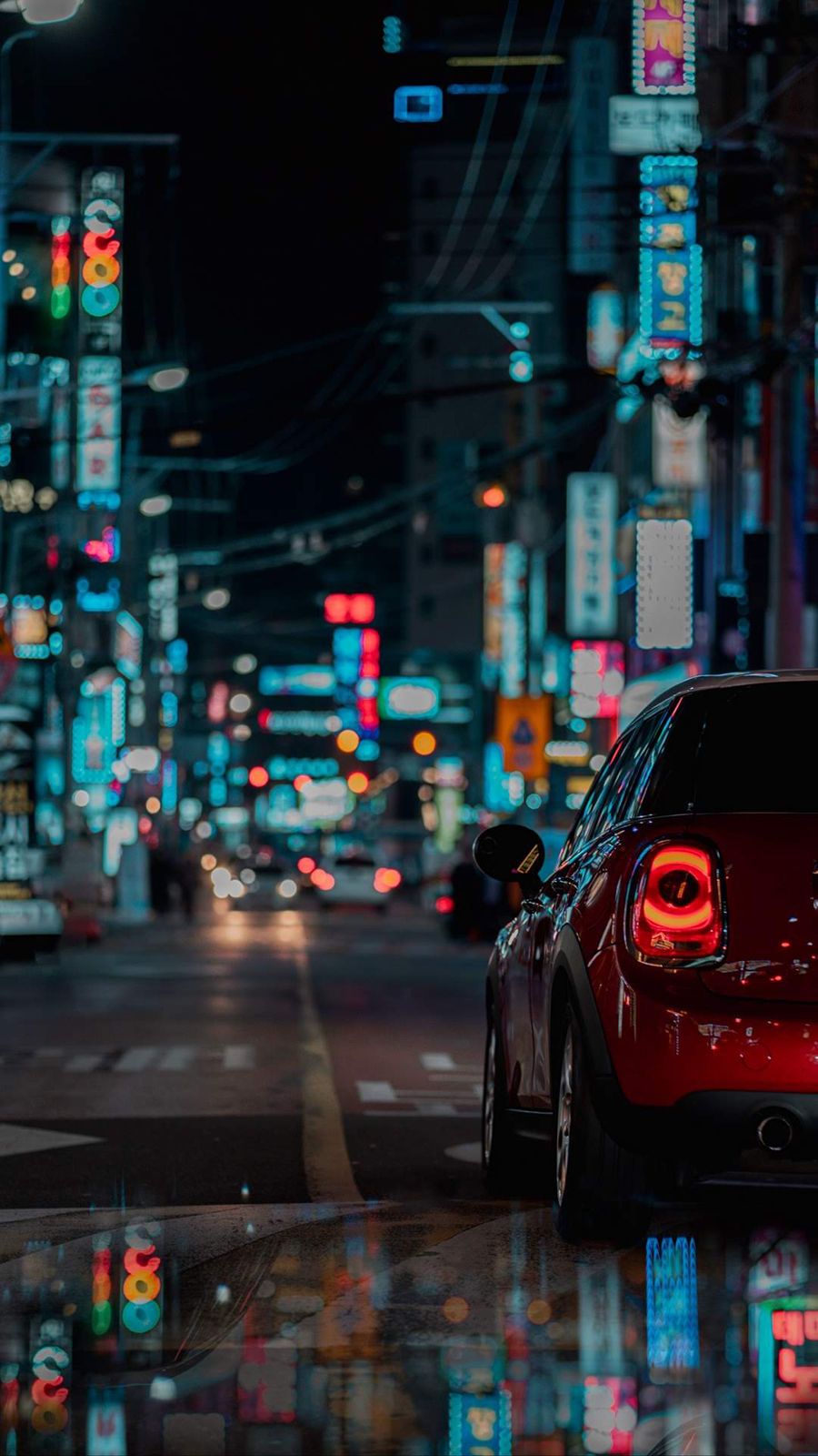 A car parked on the street at night - Cars