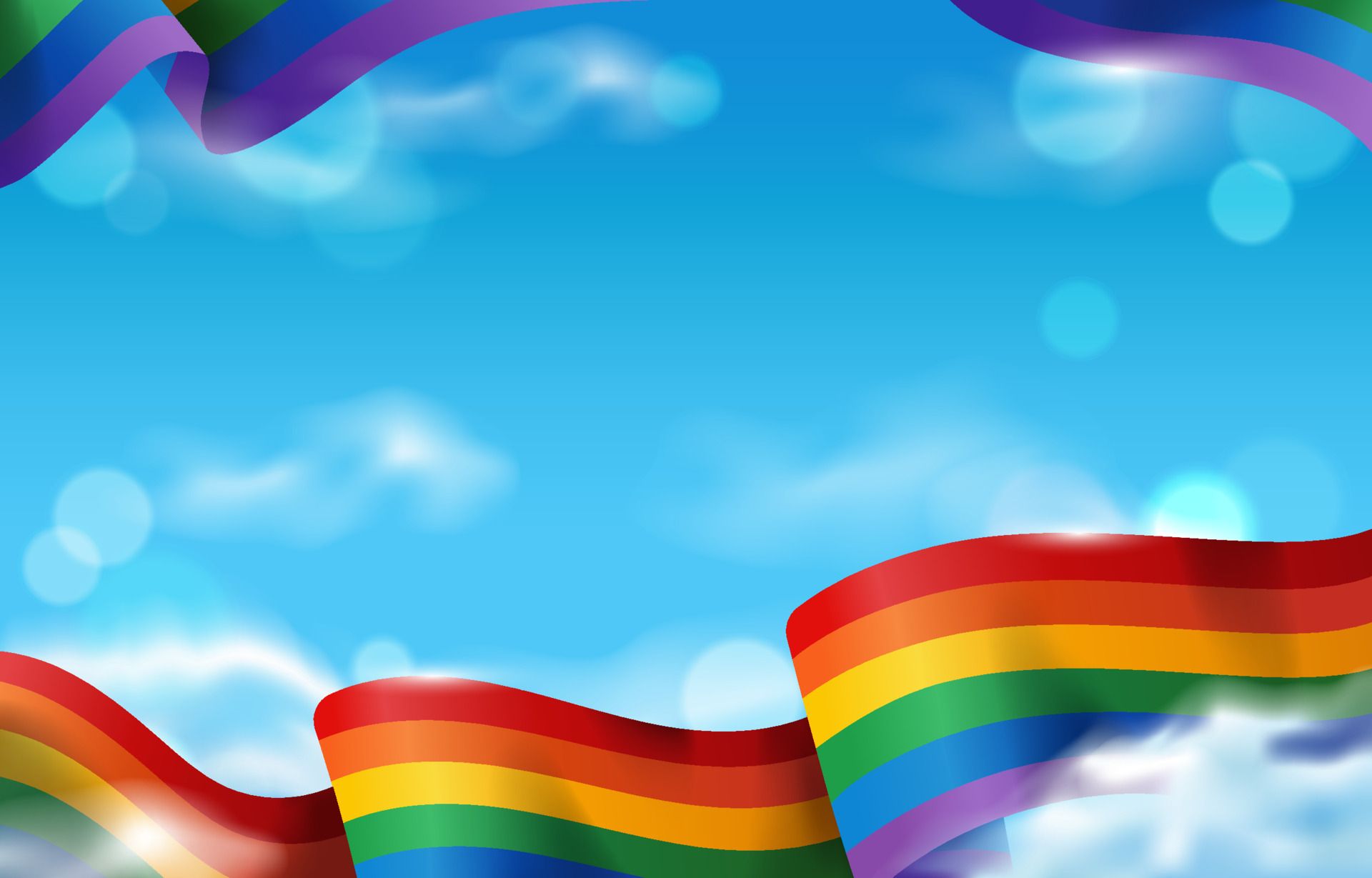 A rainbow flag waves in the wind against a blue sky. - Pride, LGBT